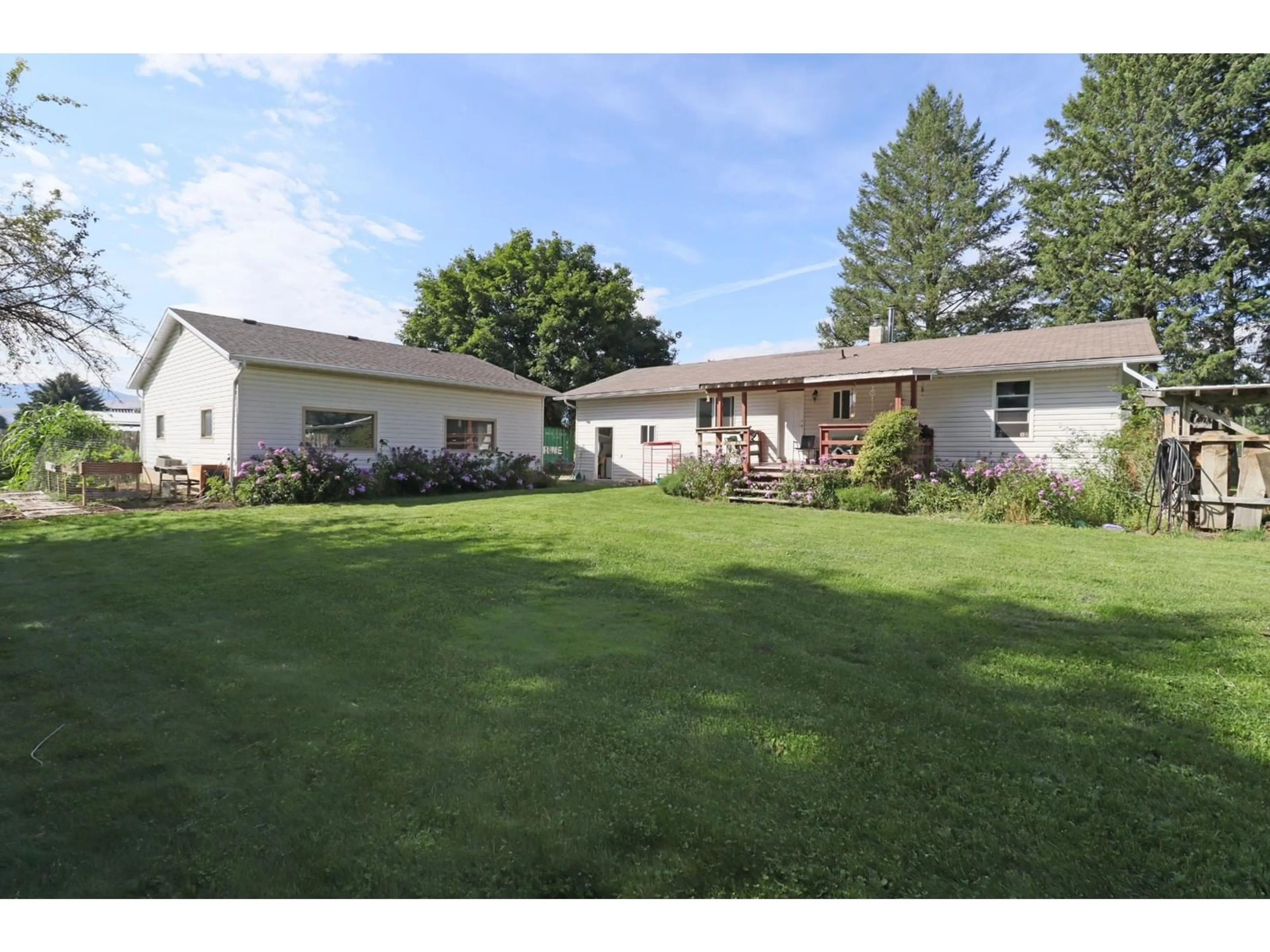 Frontside or backside of a home, the fenced backyard for 510 CARSON Road, Grand Forks British Columbia V0H1H4