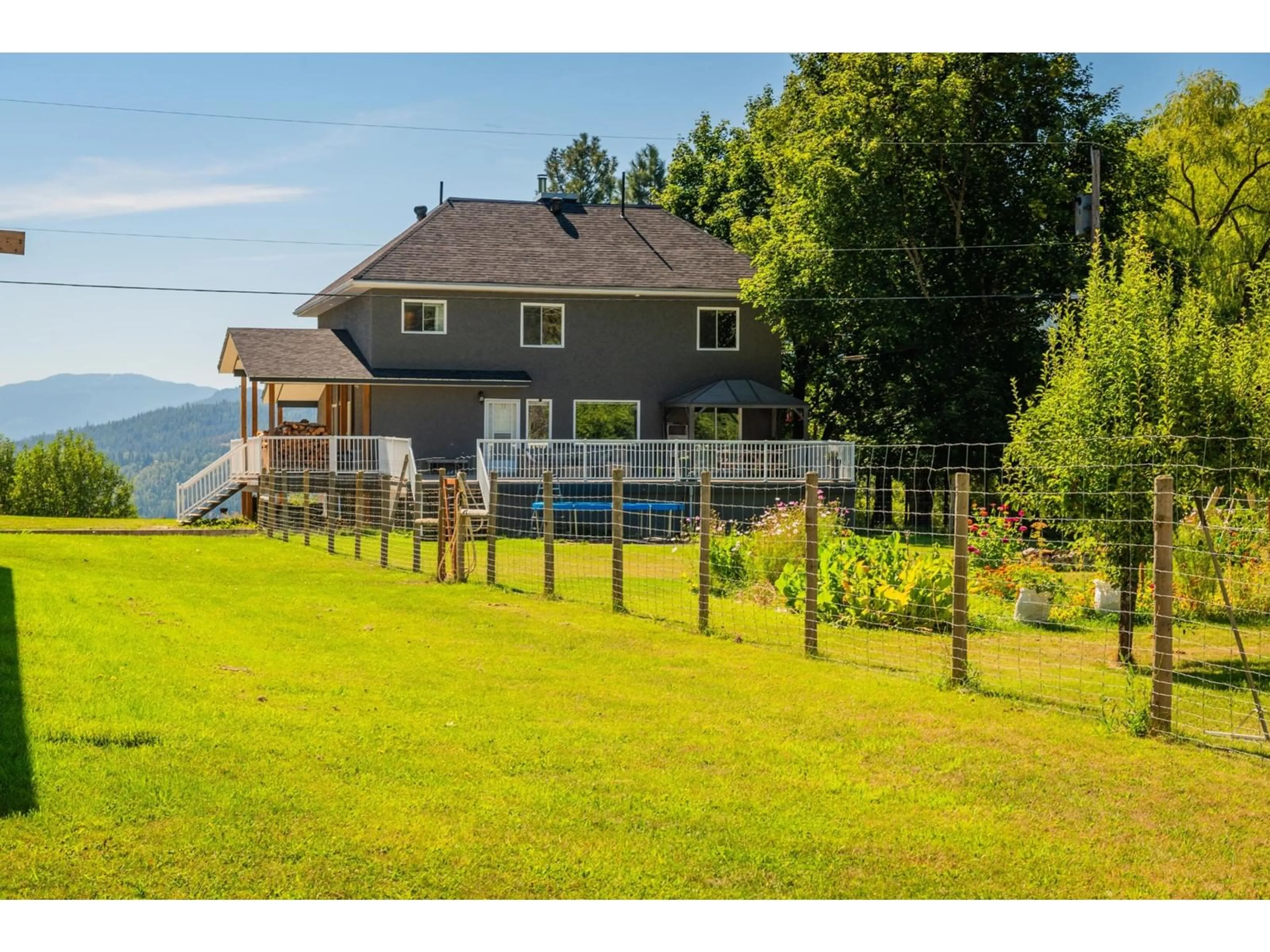 Frontside or backside of a home, the fenced backyard for 1457 PASS CREEK Road, Pass Creek British Columbia V1N4S2