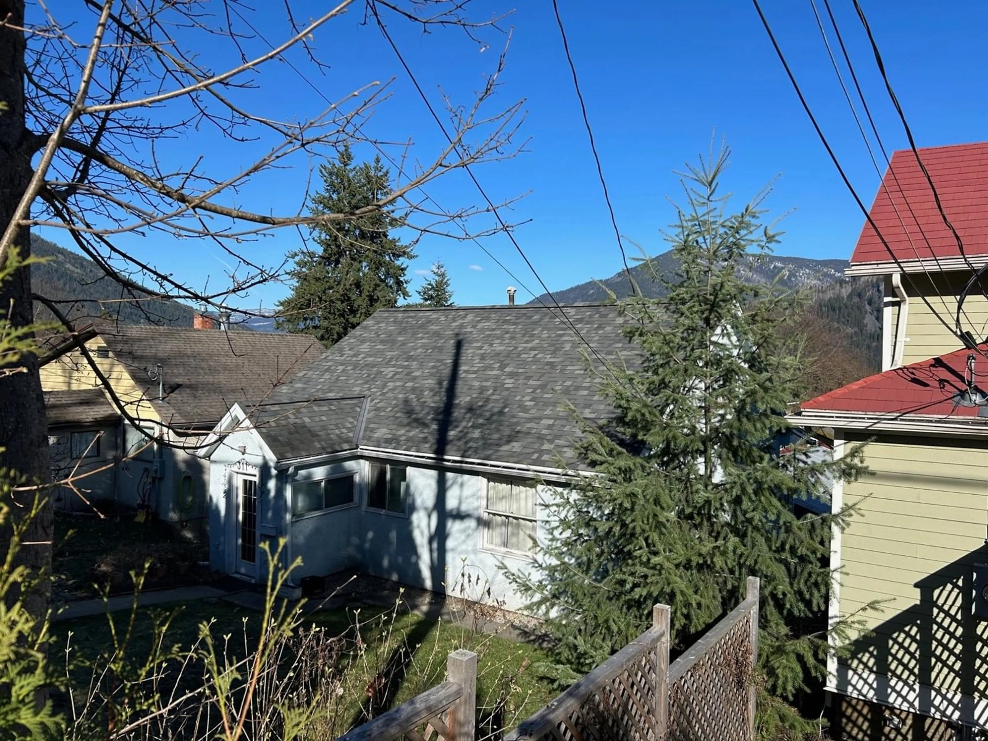 Frontside or backside of a home, the fenced backyard for 311 GORE Street, Nelson British Columbia V1L5B8