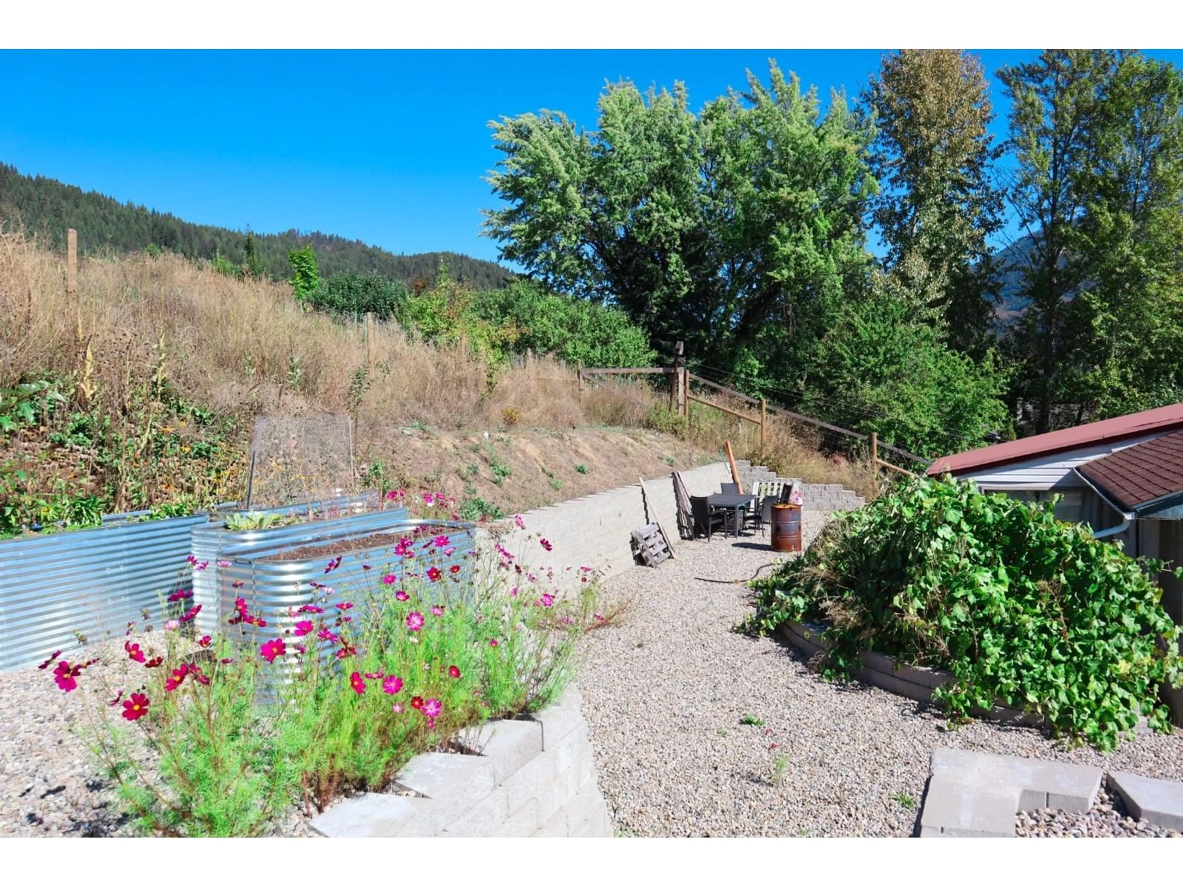 Patio, the fenced backyard for 1913 3B Highway, Fruitvale British Columbia V0G1L0