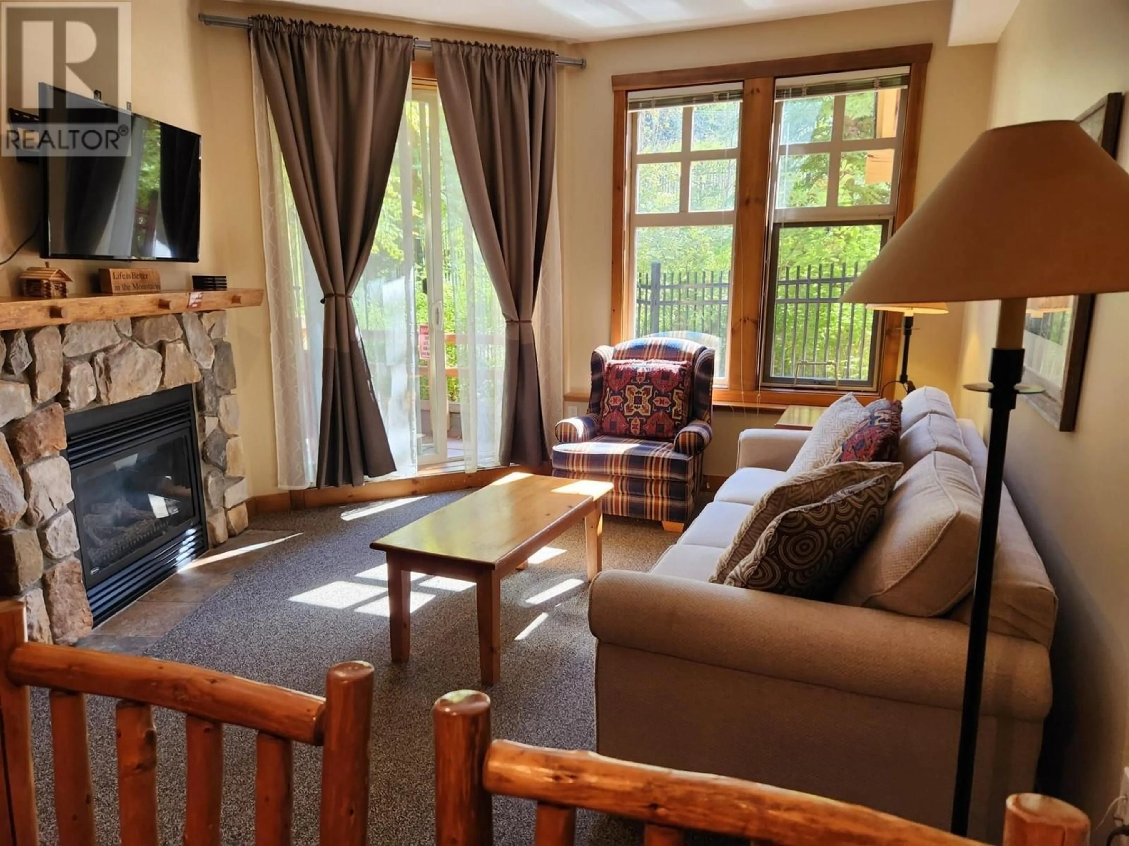 Living room with furniture, wood/laminate floor for 211 - 2090 SUMMIT DRIVE, Panorama British Columbia V0A1T0