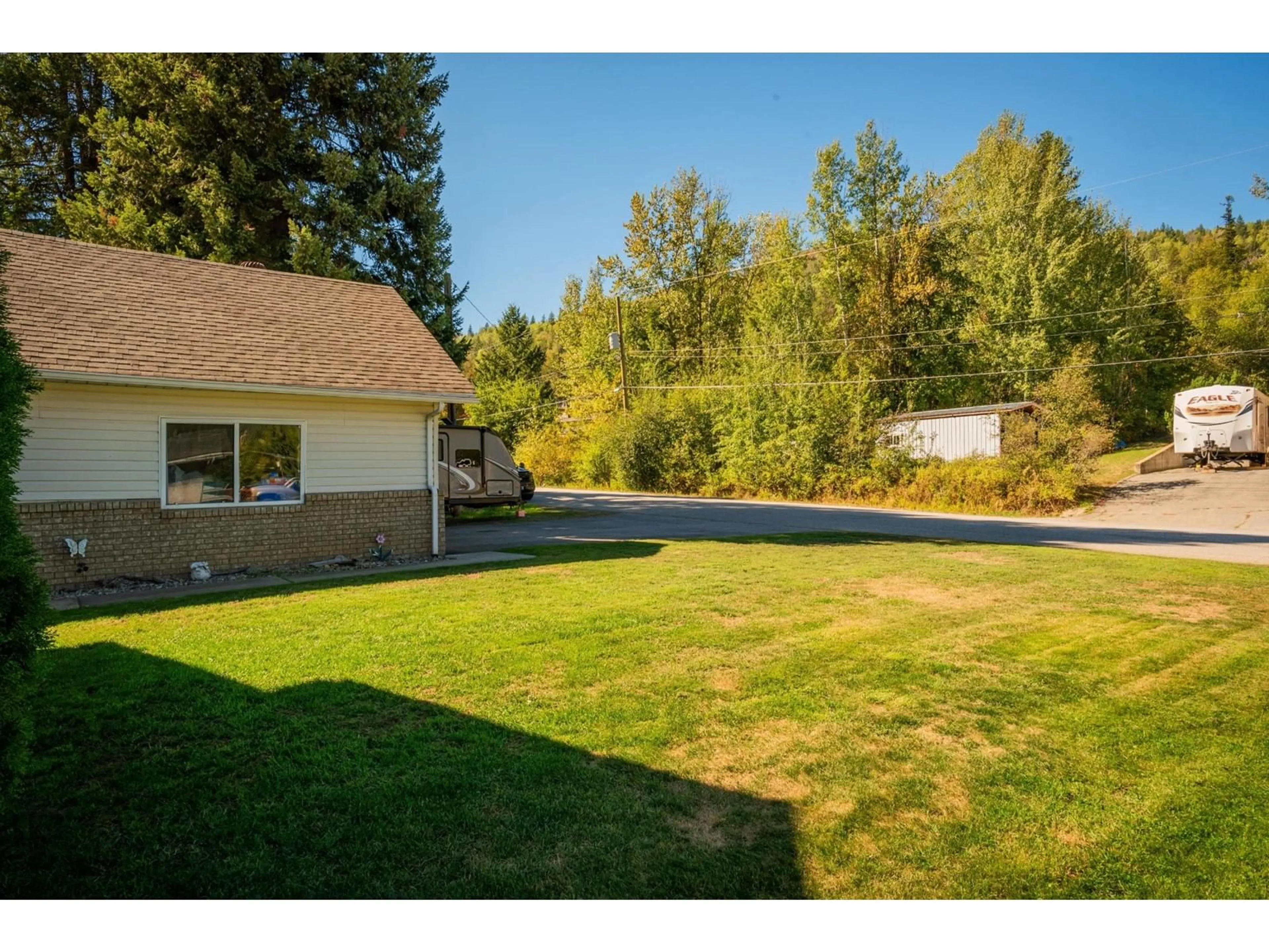 Frontside or backside of a home, the fenced backyard for 1820 FIRST Street, Fruitvale British Columbia V0G1L0