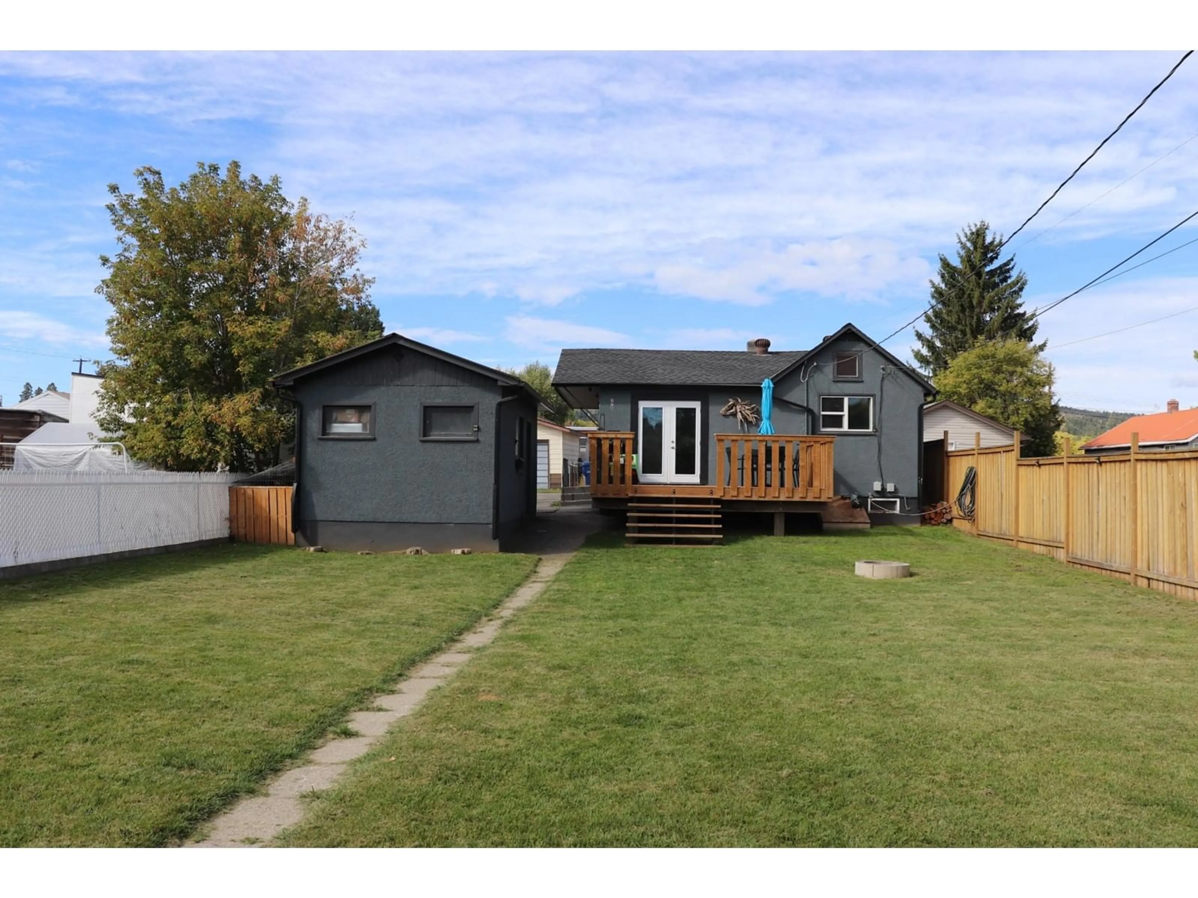 Frontside or backside of a home, the fenced backyard for 329 5TH  S Avenue, Cranbrook British Columbia V1C2G7