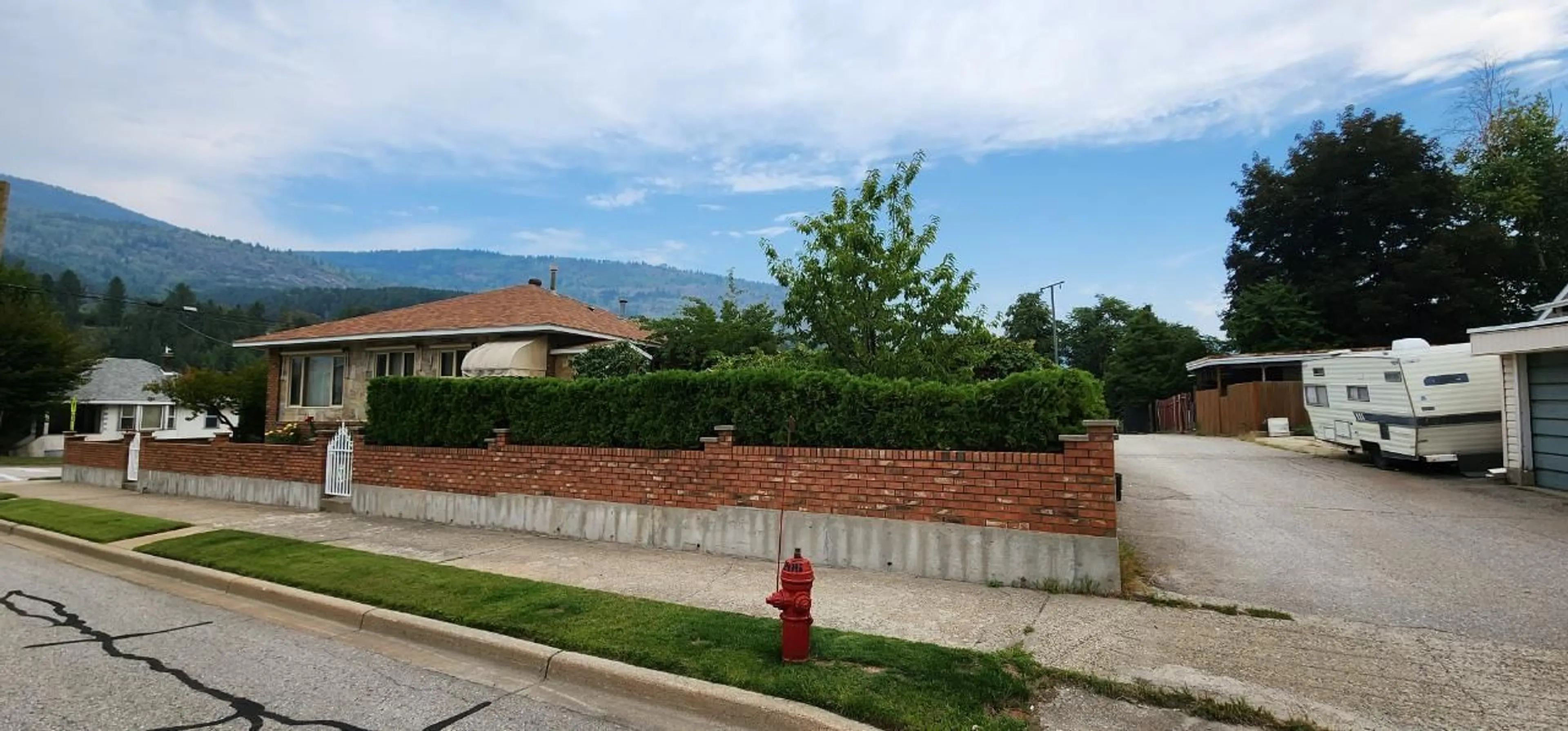 A pic from exterior of the house or condo, the fenced backyard for 1912 THIRD Avenue, Trail British Columbia V1R1R4