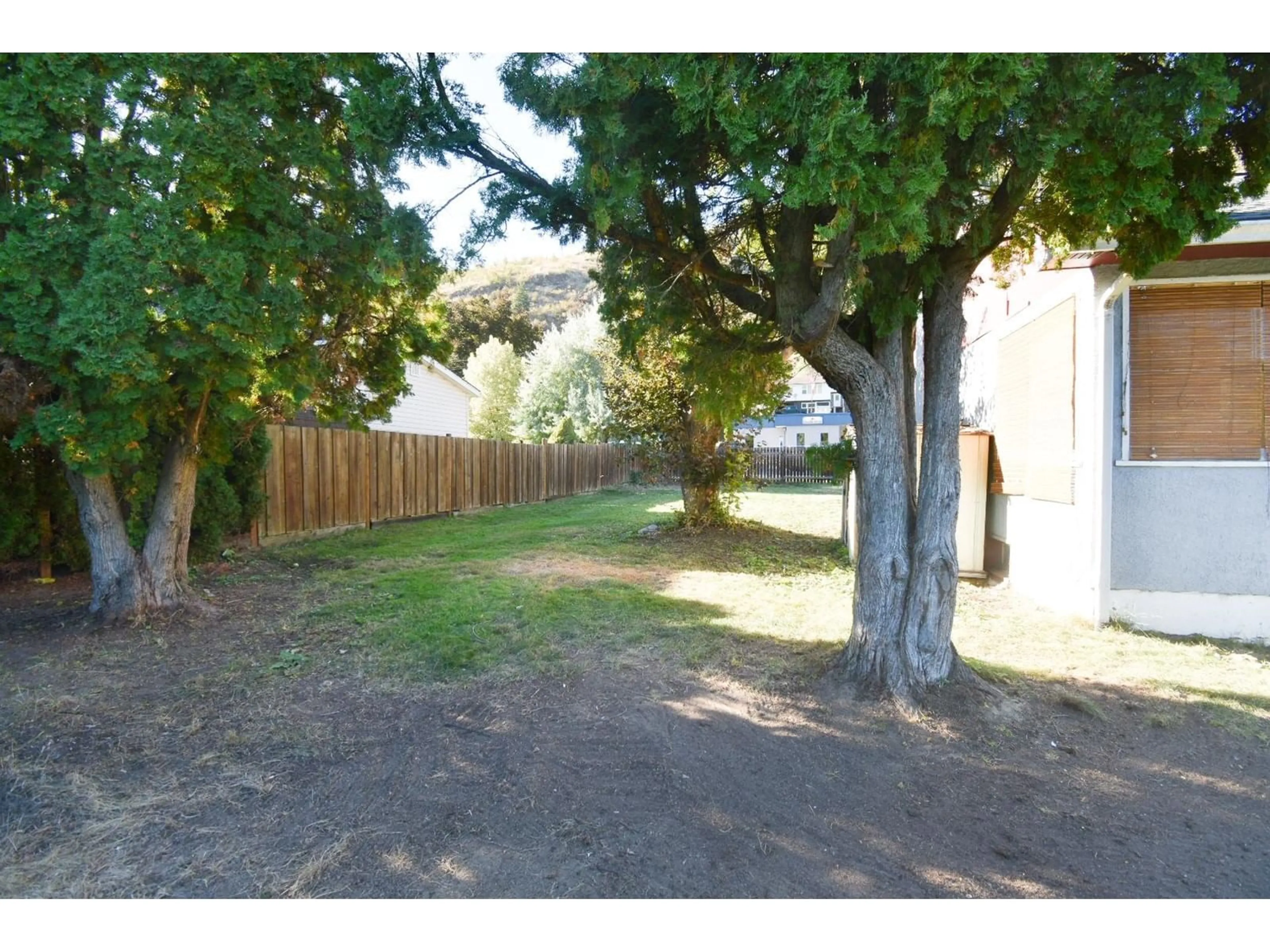 Frontside or backside of a home, the fenced backyard for 560 10TH Avenue, Montrose British Columbia V0G1P0