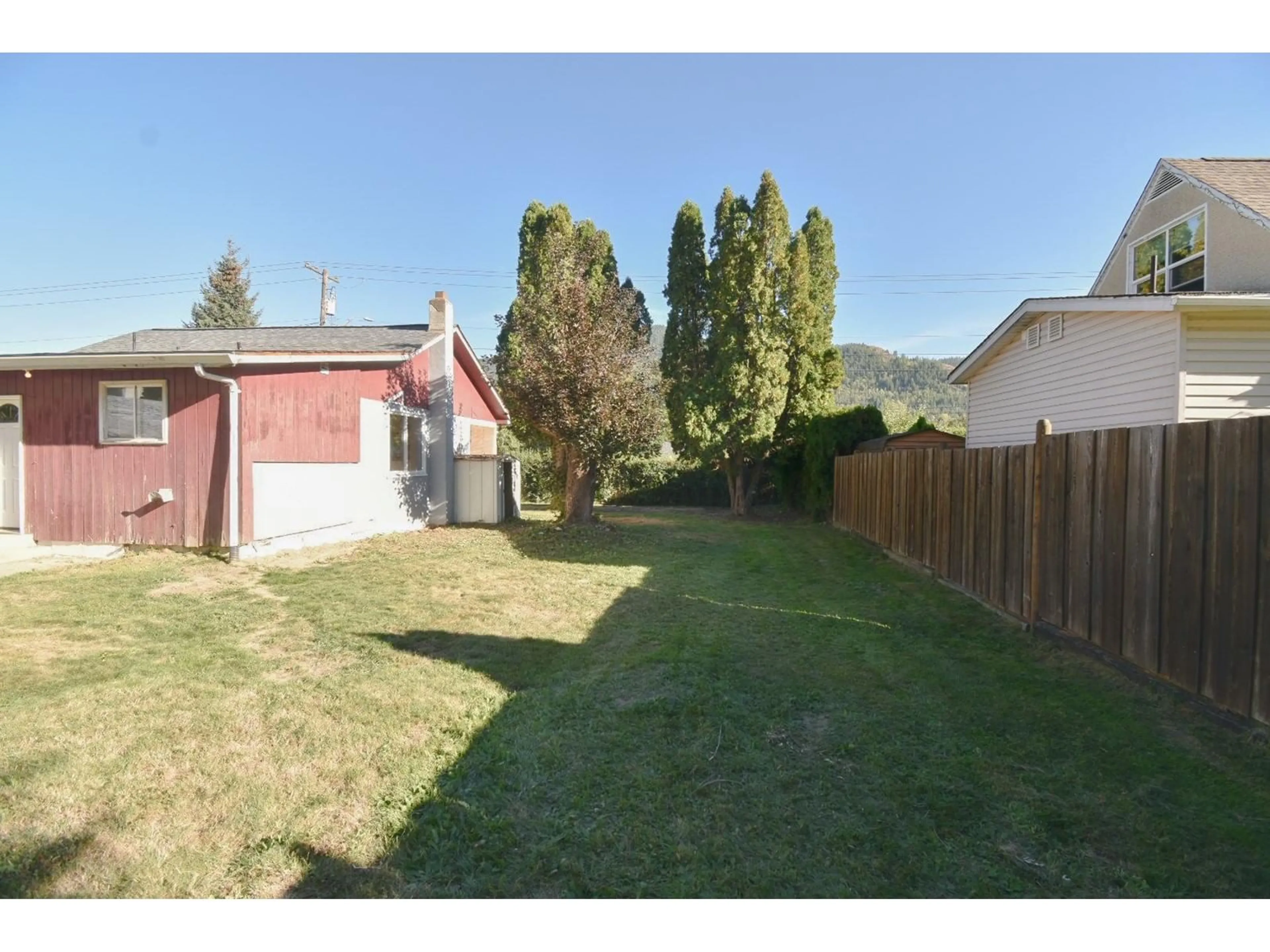 Frontside or backside of a home, the fenced backyard for 560 10TH Avenue, Montrose British Columbia V0G1P0