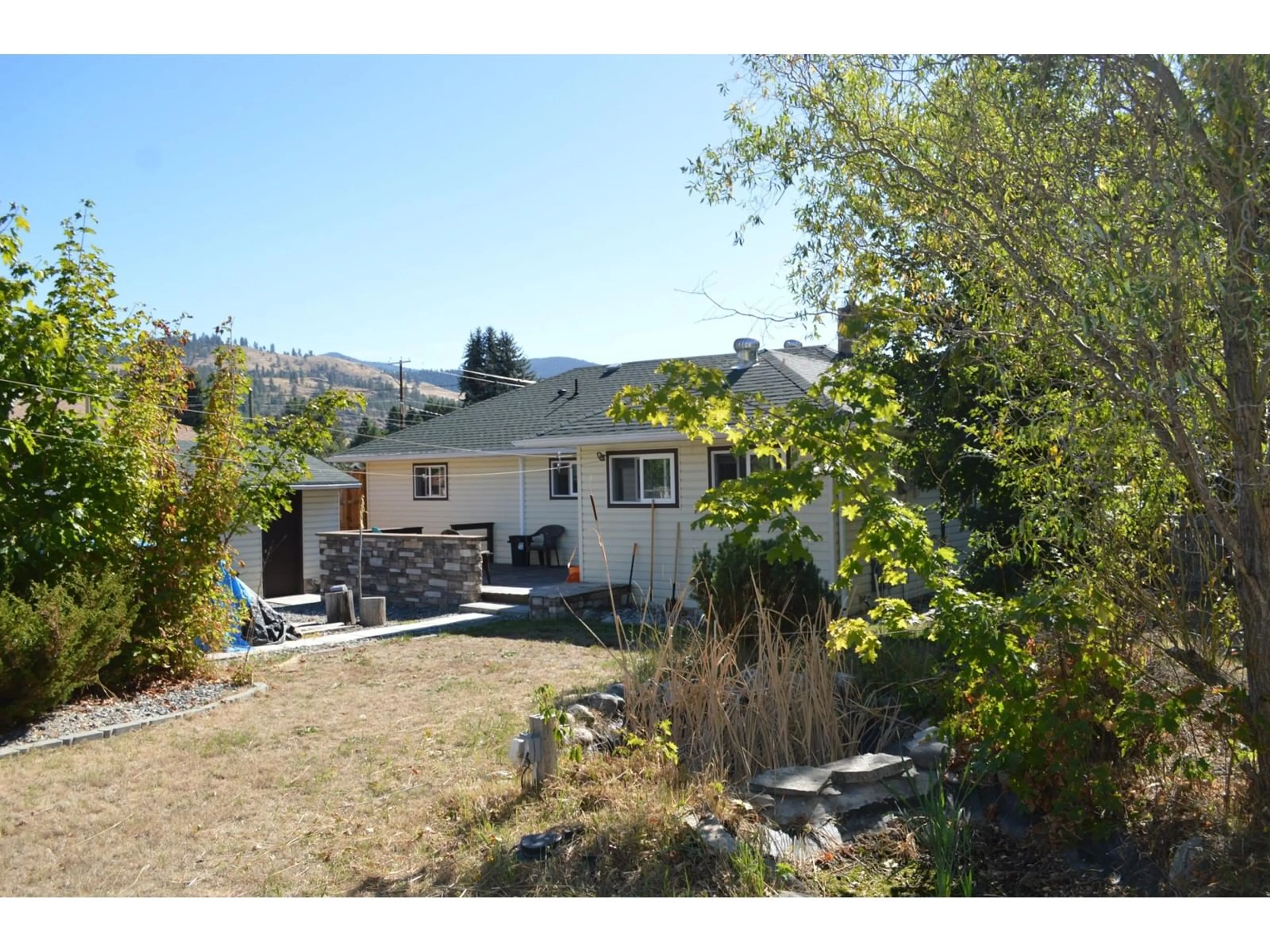 Frontside or backside of a home, the fenced backyard for 519 HARTLAND Avenue, Midway British Columbia V0H1M0