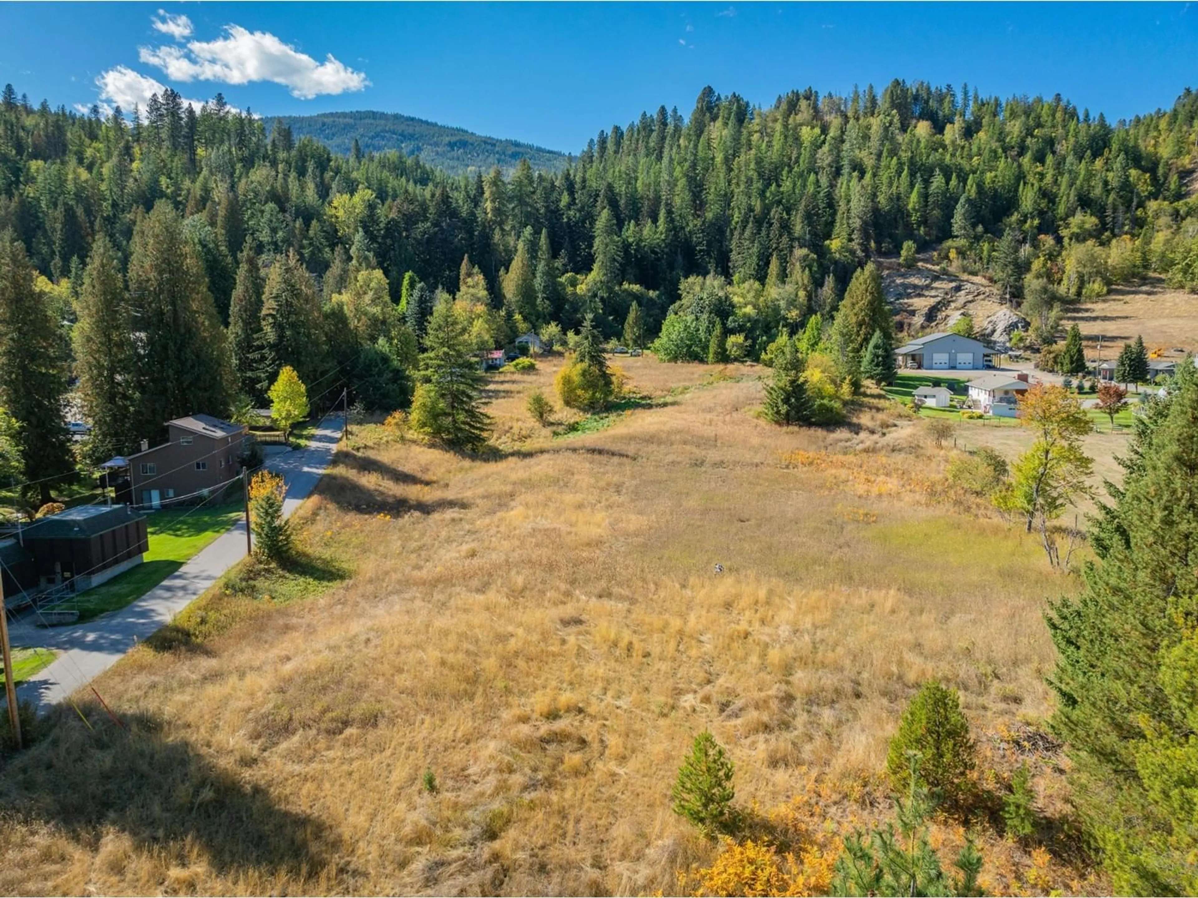 A pic from exterior of the house or condo, the fenced backyard for 738 MEADOWLARK Lane, Castlegar British Columbia V1N2K4