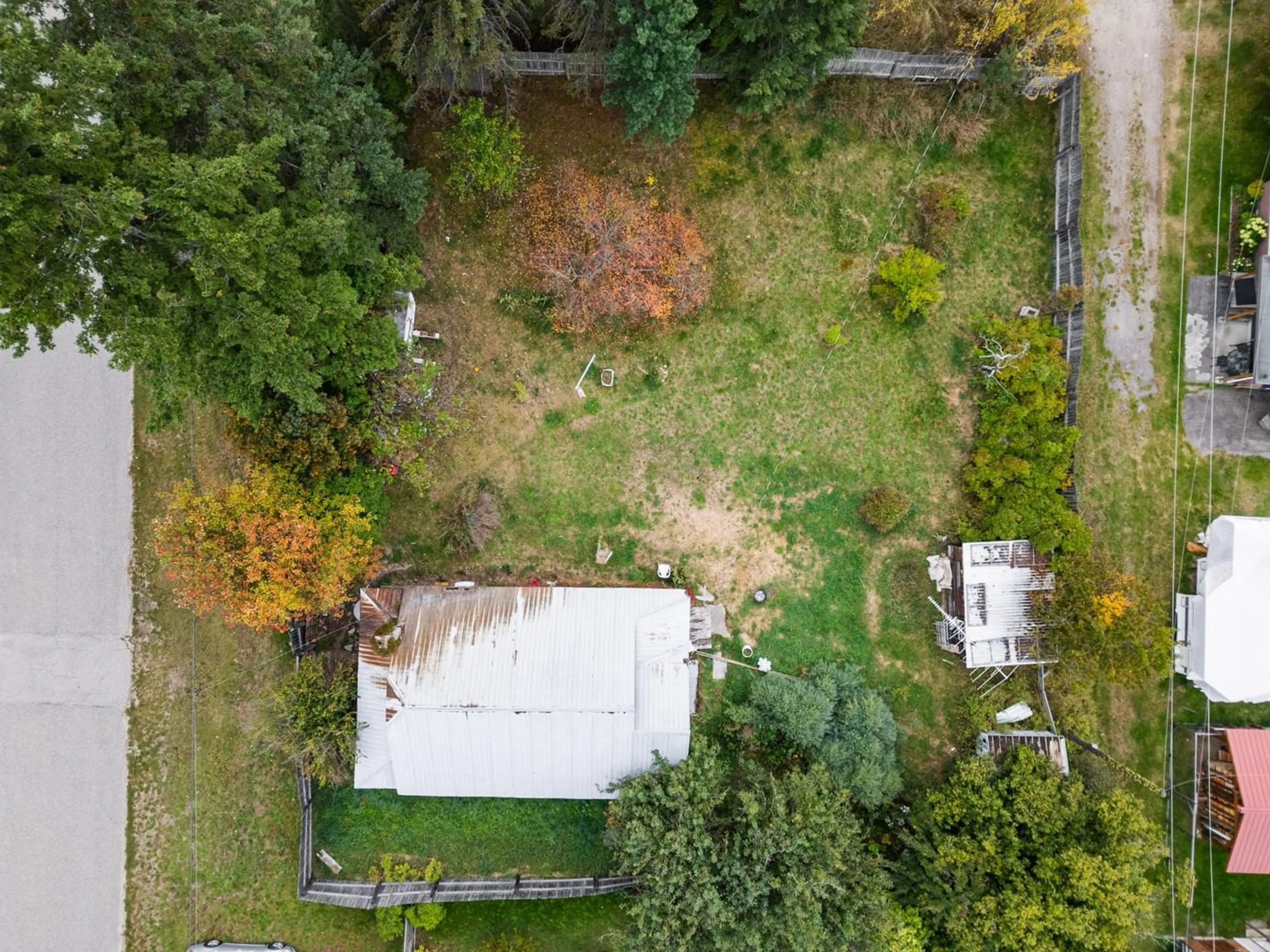 Frontside or backside of a home, the fenced backyard for 713 ARTHUR Street, Slocan British Columbia V0G2C0