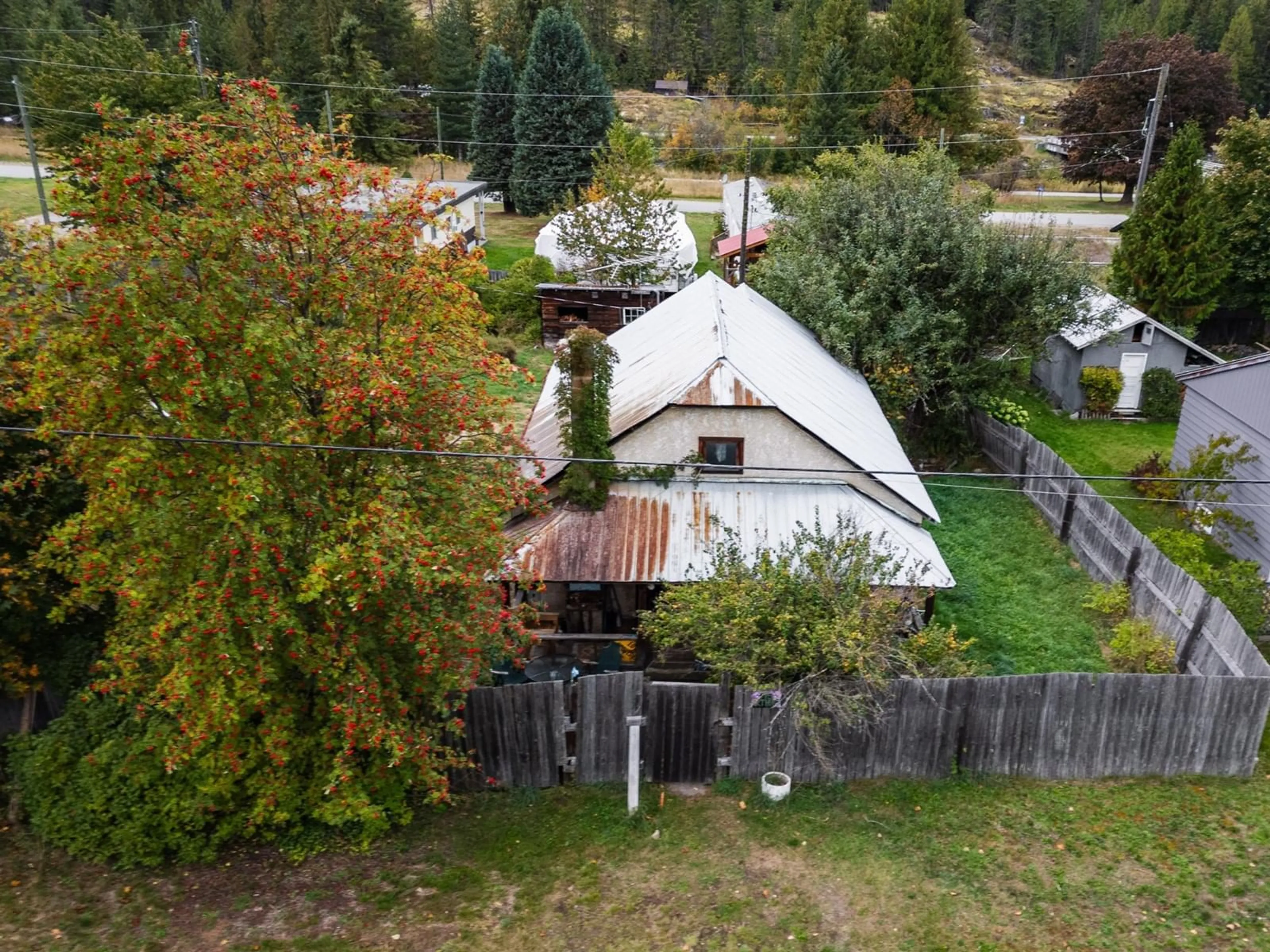 Frontside or backside of a home, the fenced backyard for 713 ARTHUR Street, Slocan British Columbia V0G2C0