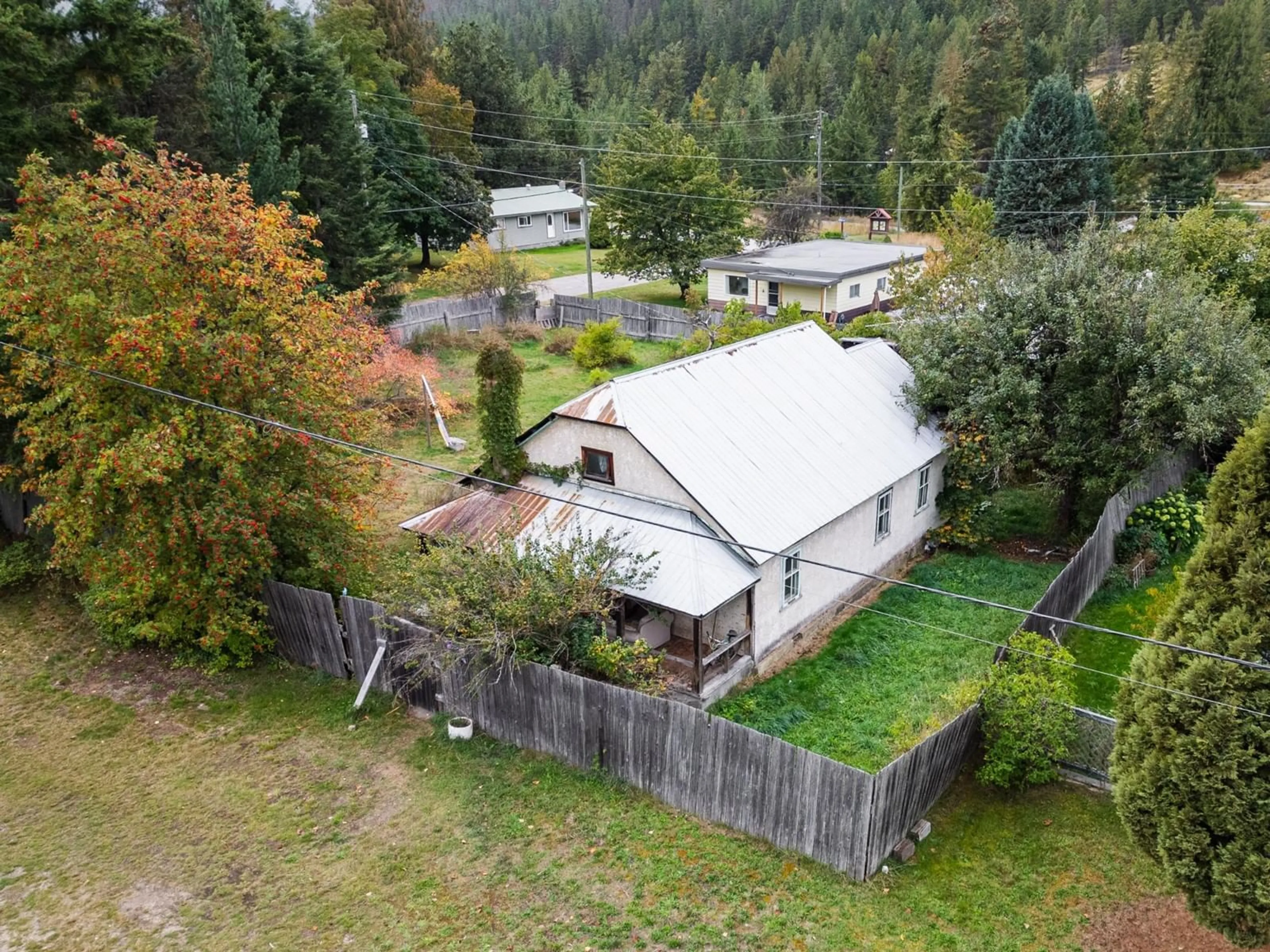 Frontside or backside of a home, the fenced backyard for 713 ARTHUR Street, Slocan British Columbia V0G2C0