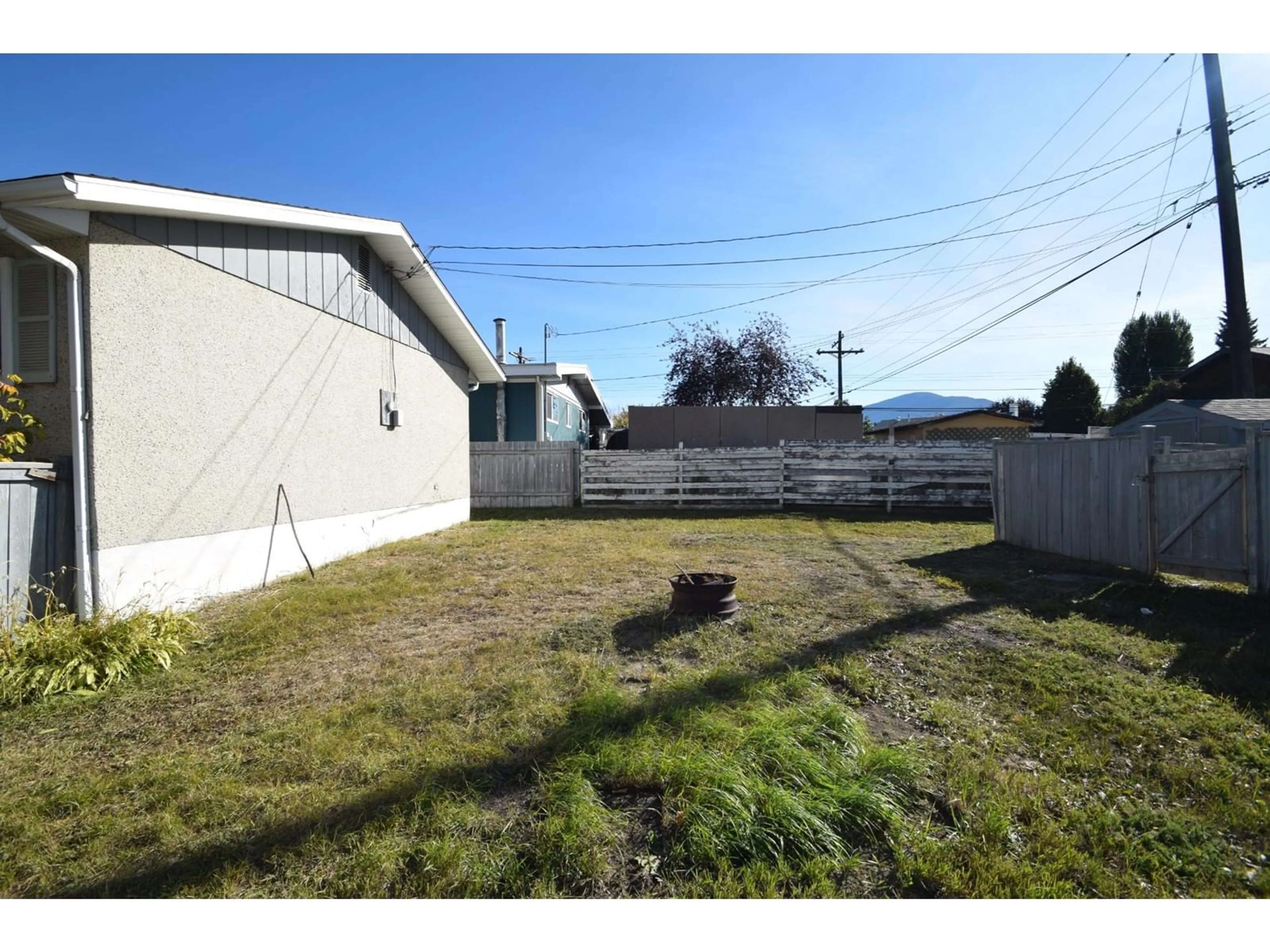 A pic from exterior of the house or condo, the fenced backyard for 301 11TH  S Street, Cranbrook British Columbia V1C1V1