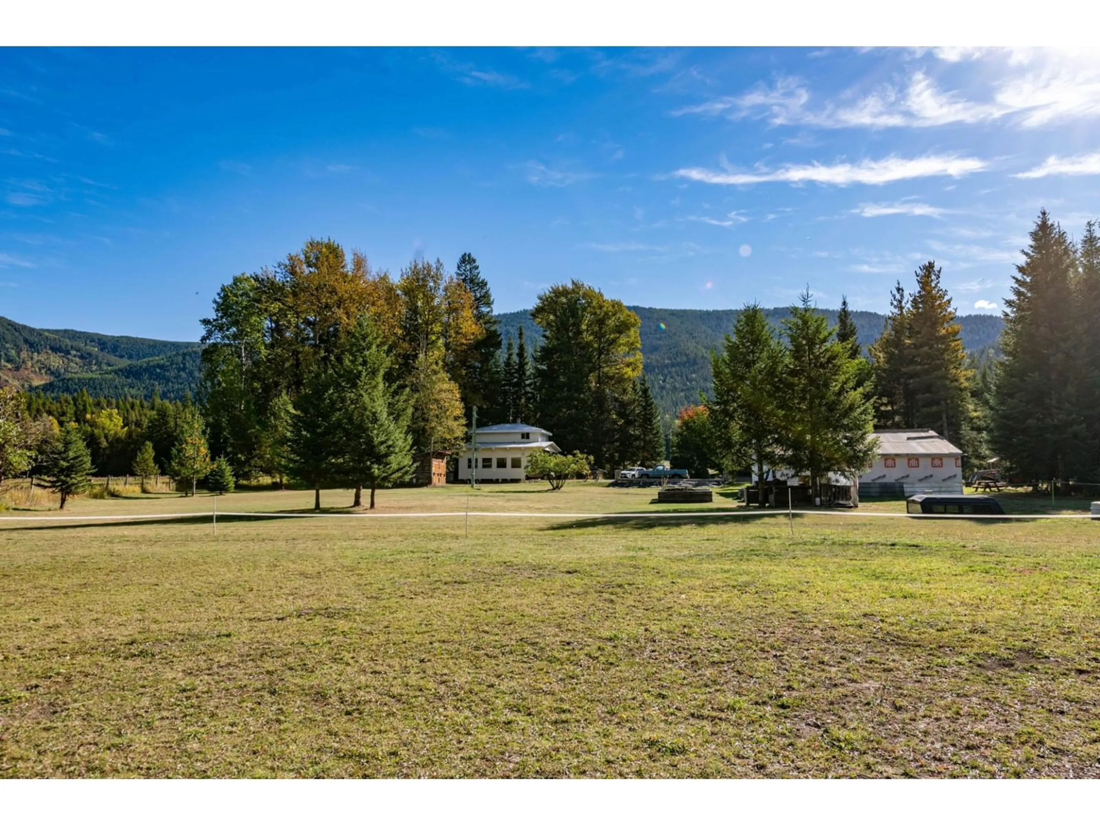 A pic from exterior of the house or condo, the fenced backyard for 9848 6 Highway, Salmo British Columbia V0G1Z0