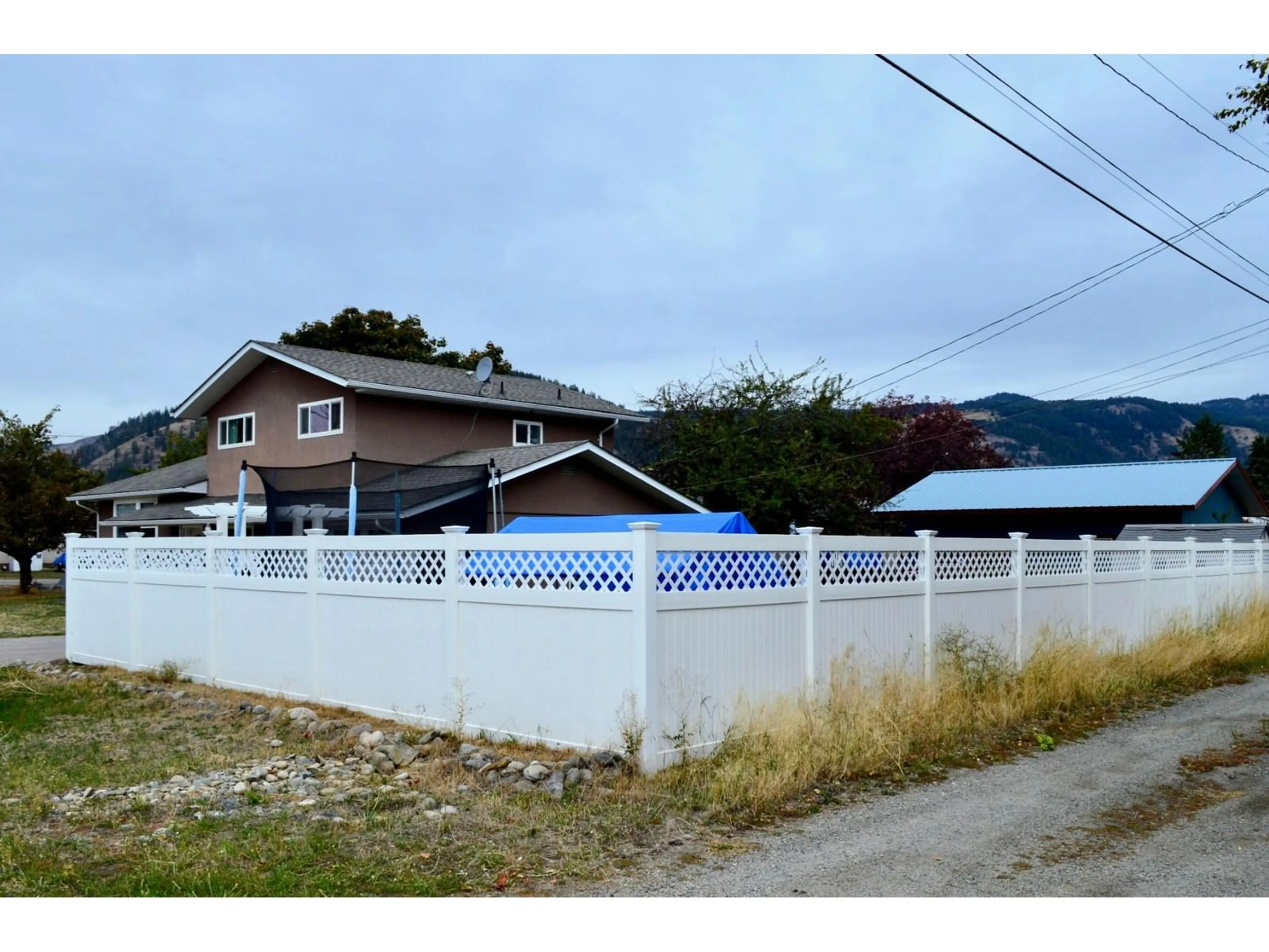 Frontside or backside of a home, the fenced backyard for 2181 72ND Avenue, Grand Forks British Columbia V0H1H0