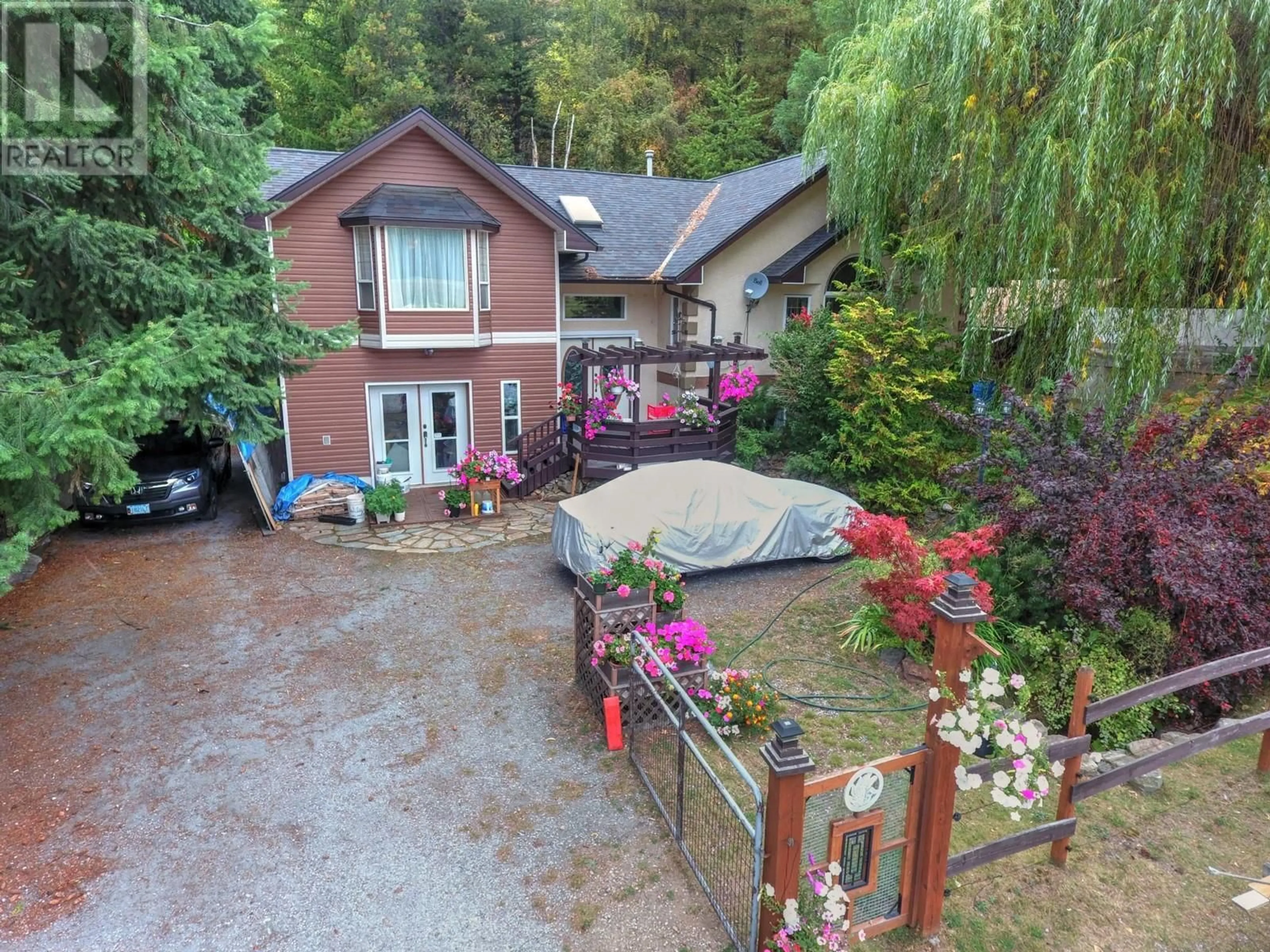 A pic from outside/outdoor area/front of a property/back of a property/a pic from drone, street for 930 CHINA CREEK ROAD, Genelle British Columbia V0G1G0