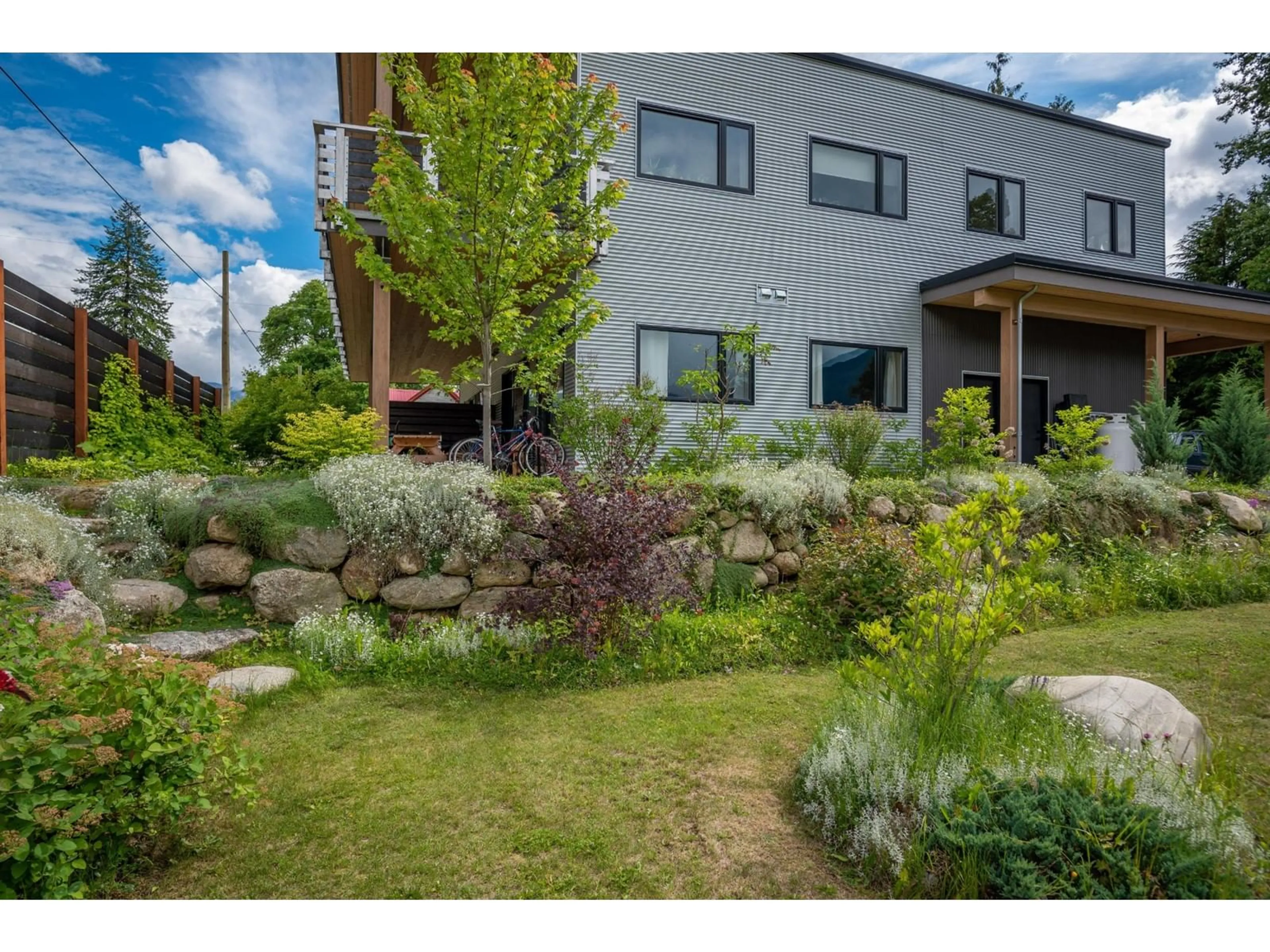 Frontside or backside of a home, the fenced backyard for 617 HAROLD Street, Slocan British Columbia V0G2C0