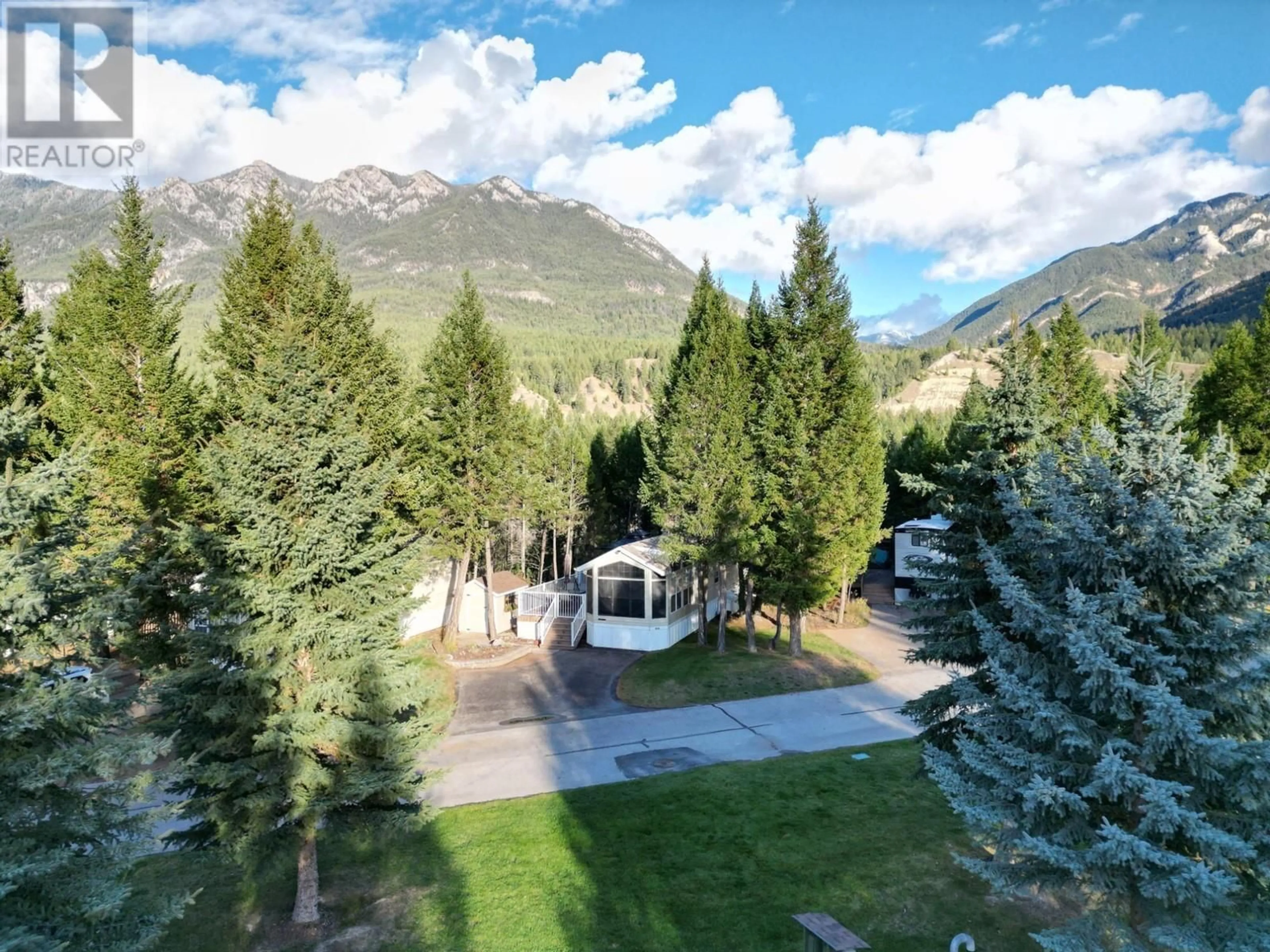 A pic from exterior of the house or condo, the fenced backyard for 4858 LYNX Drive, Radium Hot Springs British Columbia V0A1M0