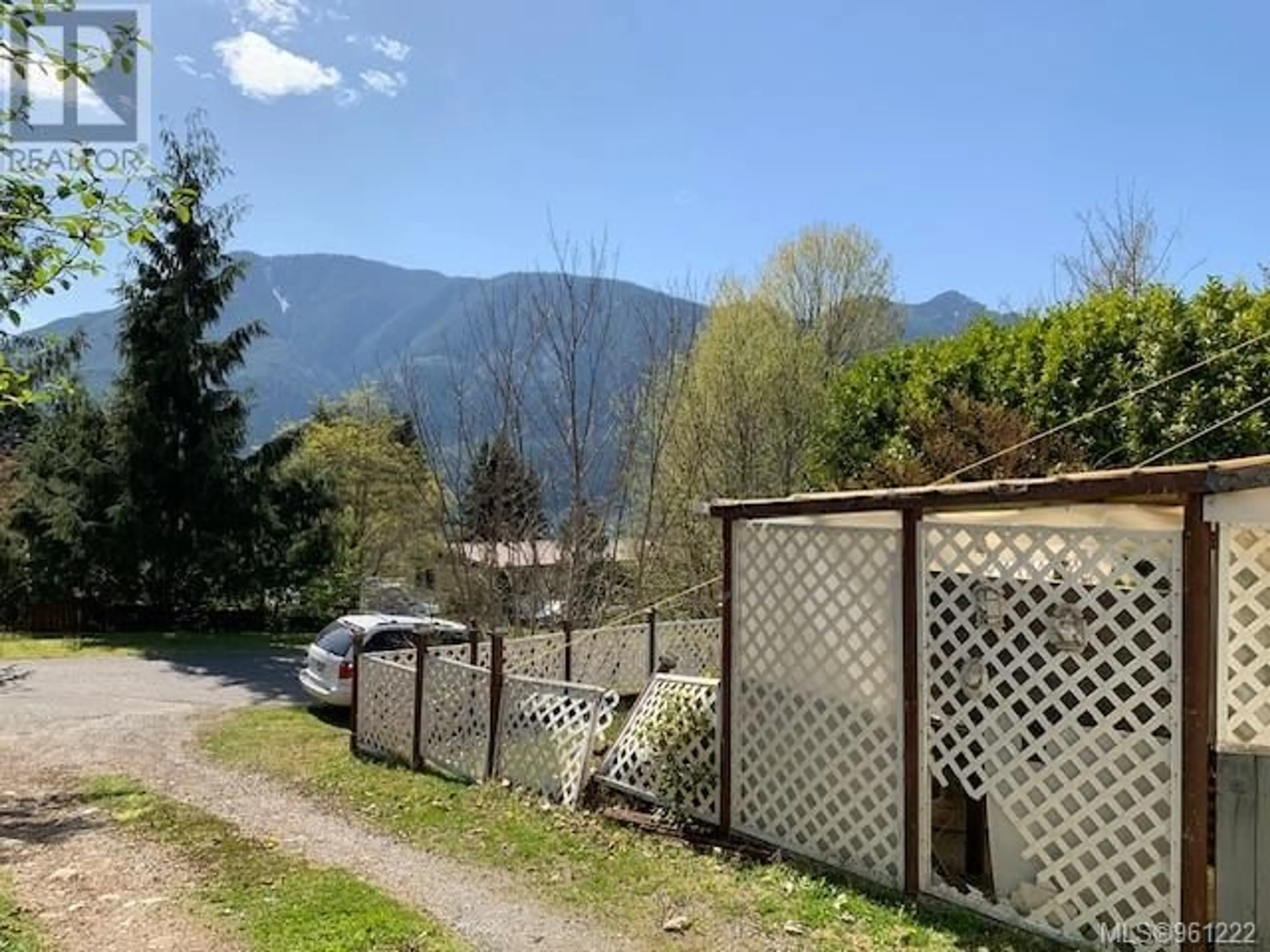 Frontside or backside of a home, the fenced backyard for 1203 Maquinna Ave, Port Alice British Columbia V0N2N0