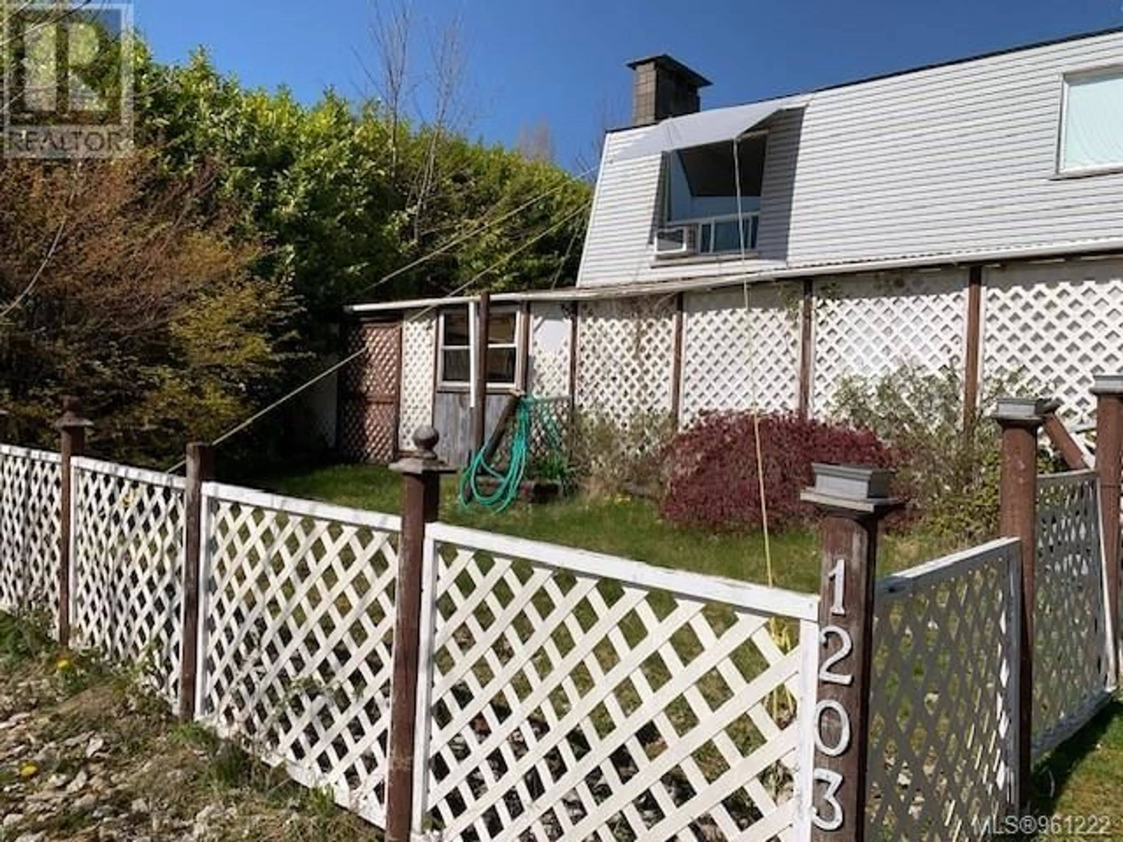 Frontside or backside of a home, the fenced backyard for 1203 Maquinna Ave, Port Alice British Columbia V0N2N0