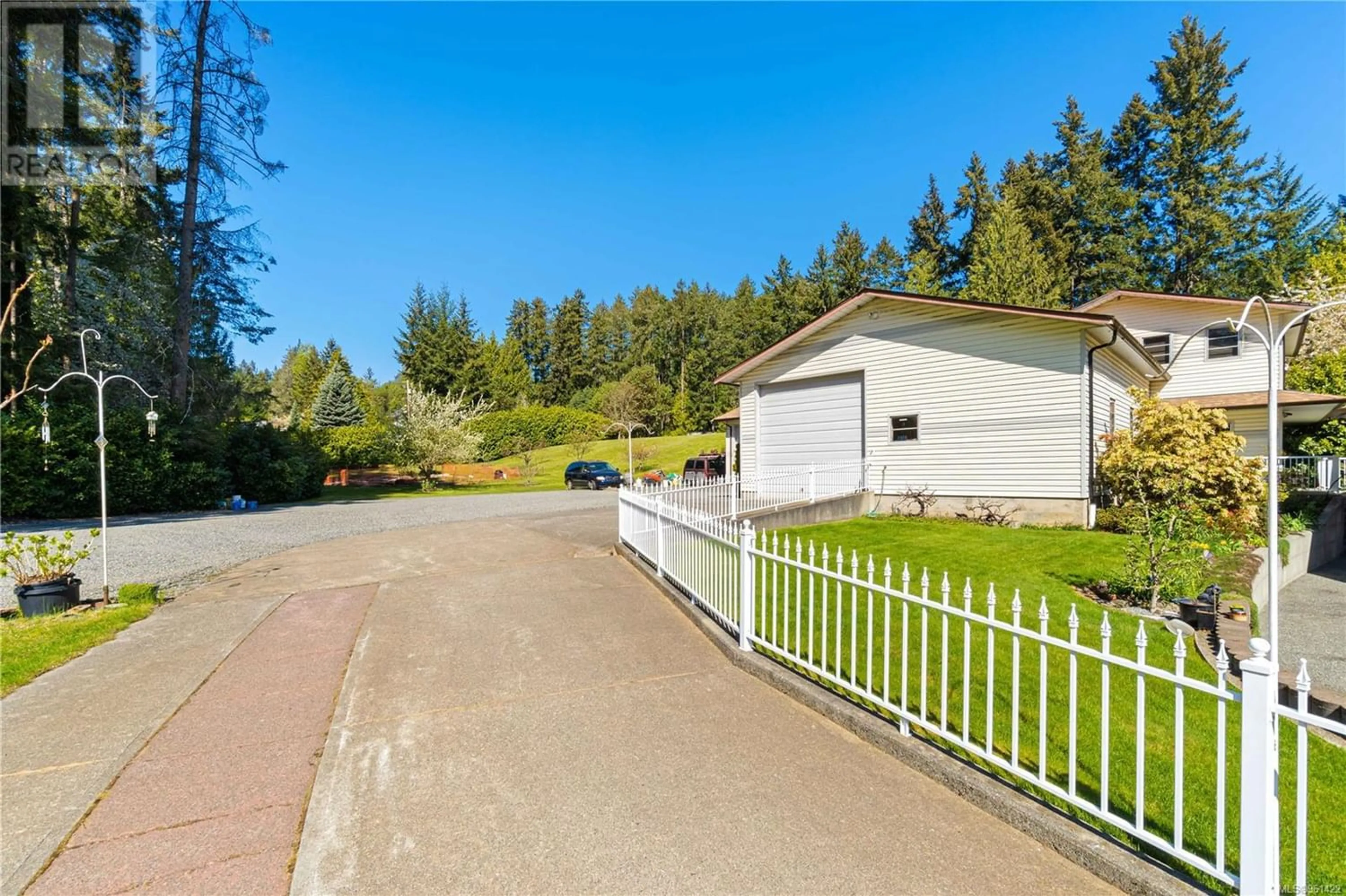 Frontside or backside of a home, the fenced backyard for 2369 South Wellington Rd, Nanaimo British Columbia V9X1S4