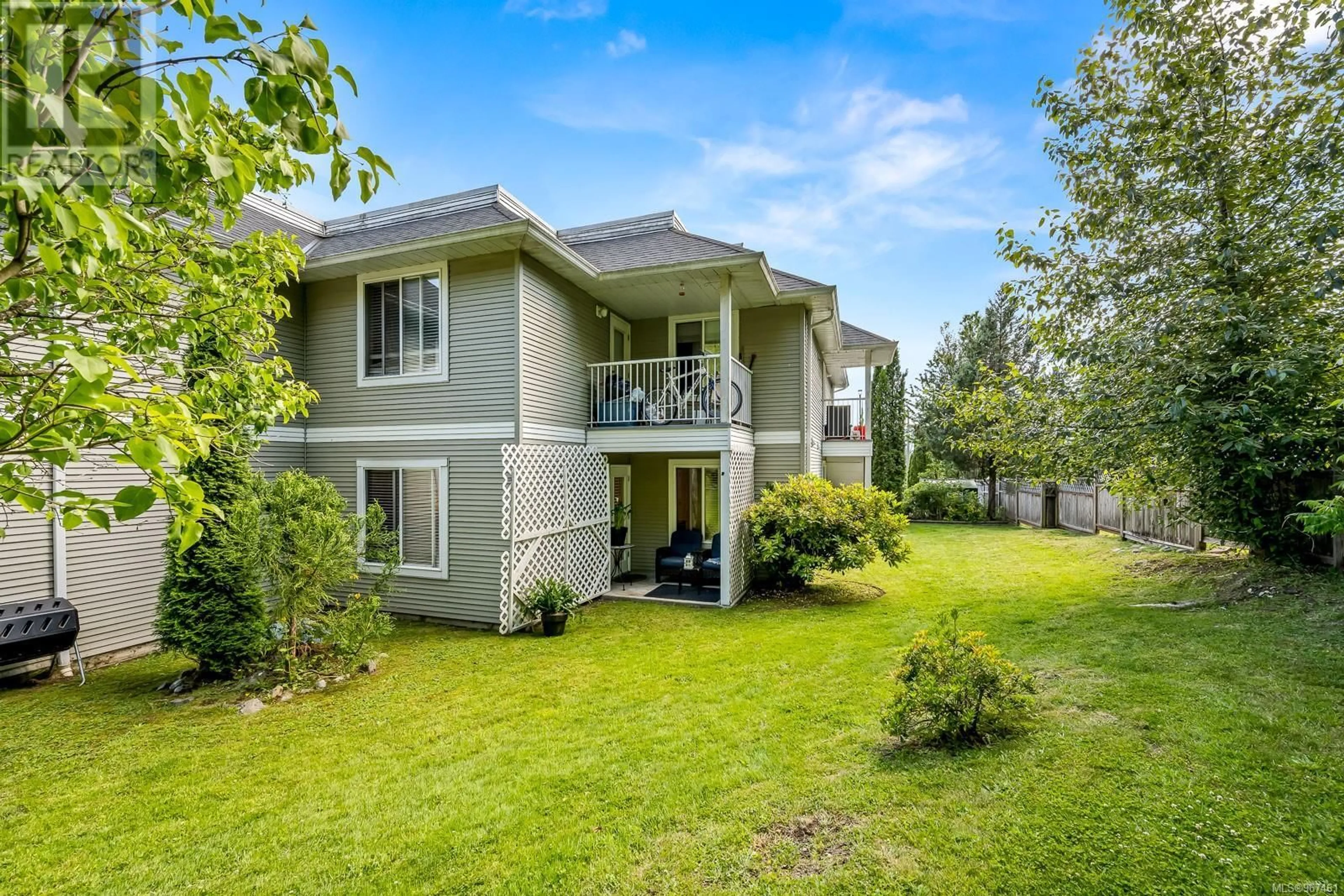 A pic from exterior of the house or condo, the fenced backyard for 101 130 Back Rd, Courtenay British Columbia V9N3W6