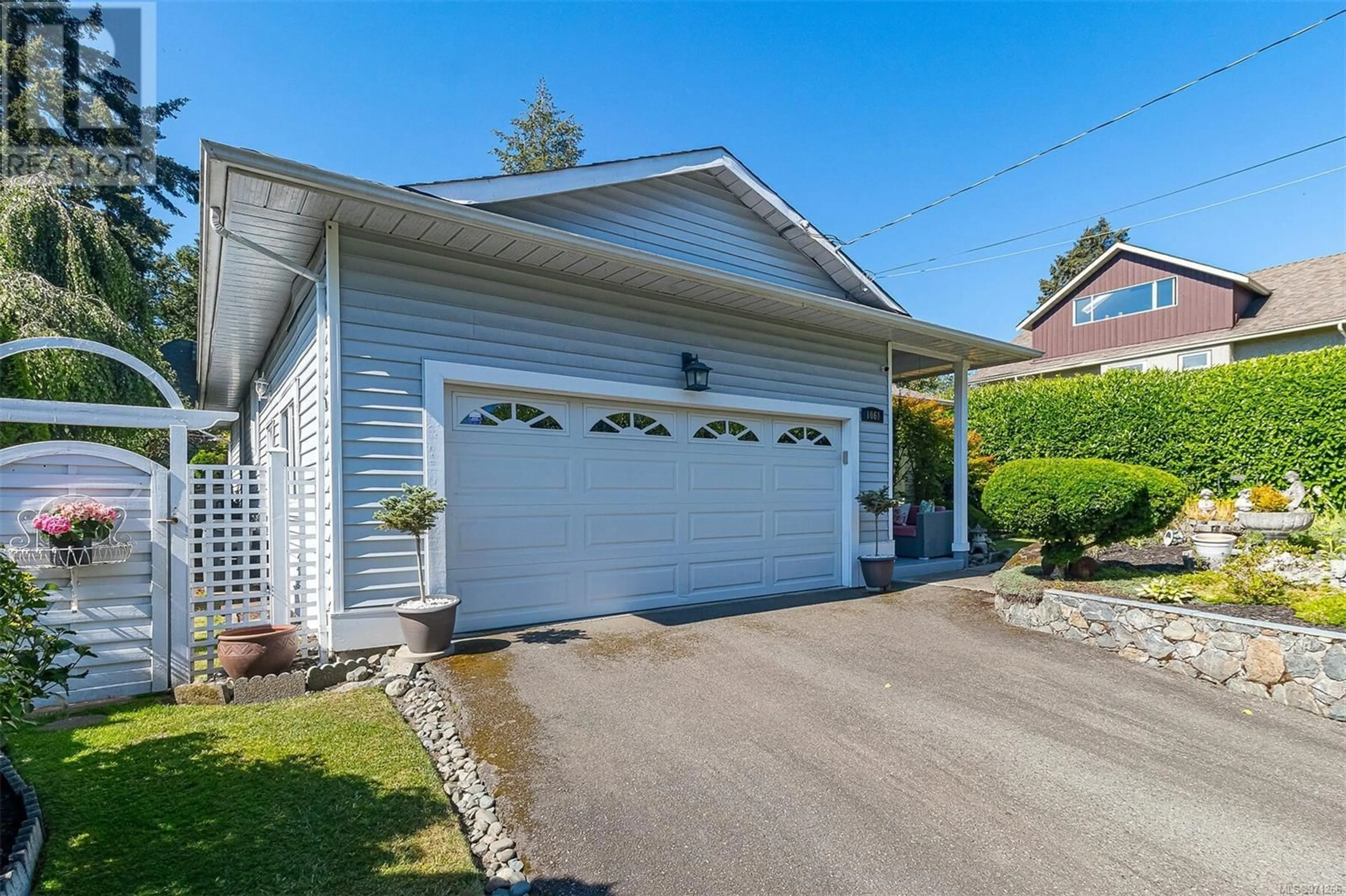 Frontside or backside of a home for 1061 Tulip Ave, Saanich British Columbia V8Z2R1