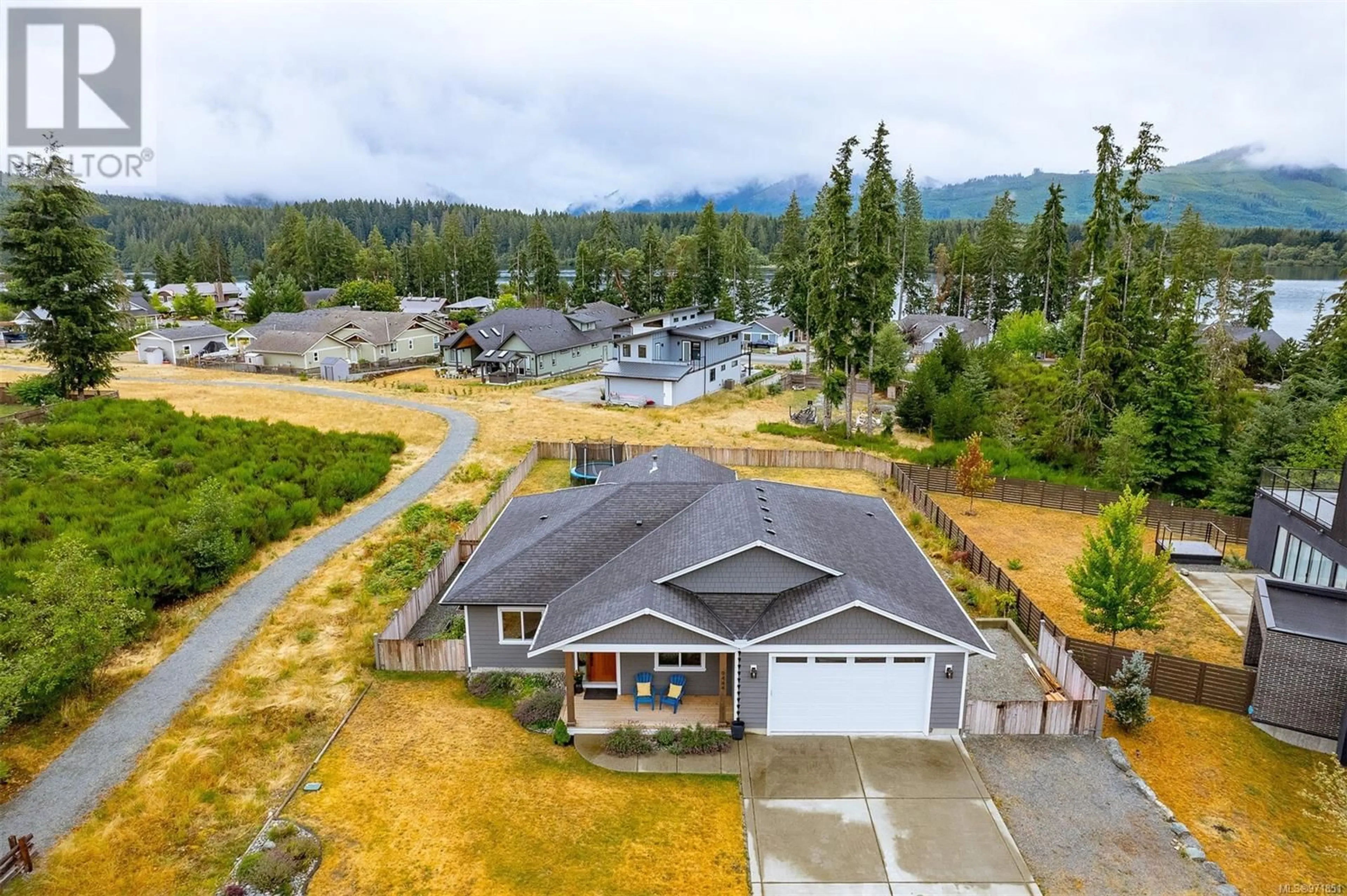 Frontside or backside of a home, the fenced backyard for 9444 Marble Bay Rd, Lake Cowichan British Columbia V0R2G1