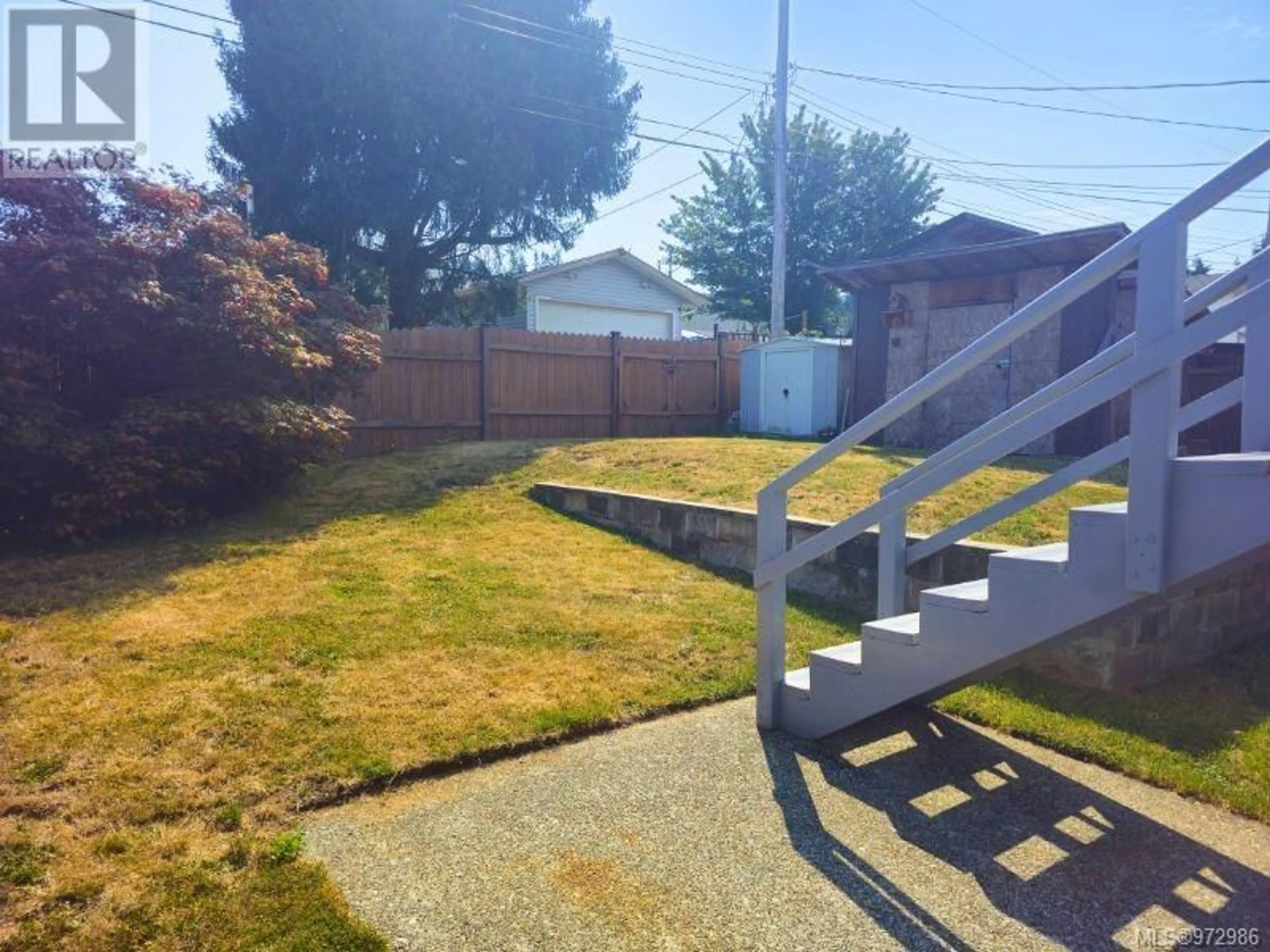 Frontside or backside of a home, the fenced backyard for 2457 9th Ave, Port Alberni British Columbia V9Y2N2