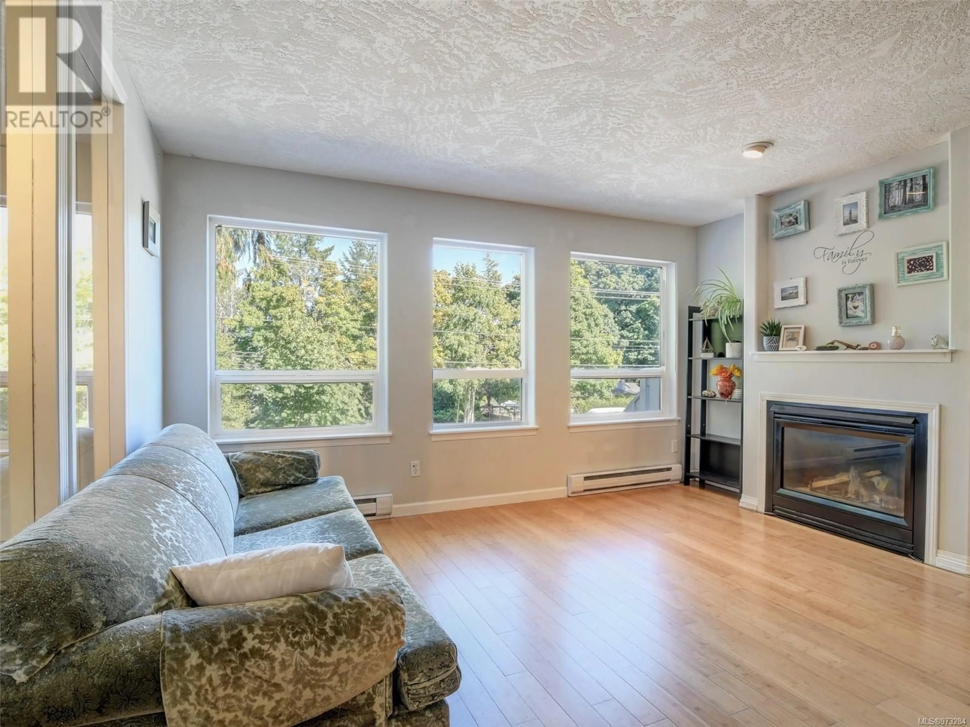 Living room with furniture, wood/laminate floor for 2436 Otter Point Rd, Sooke British Columbia V9Z0H9