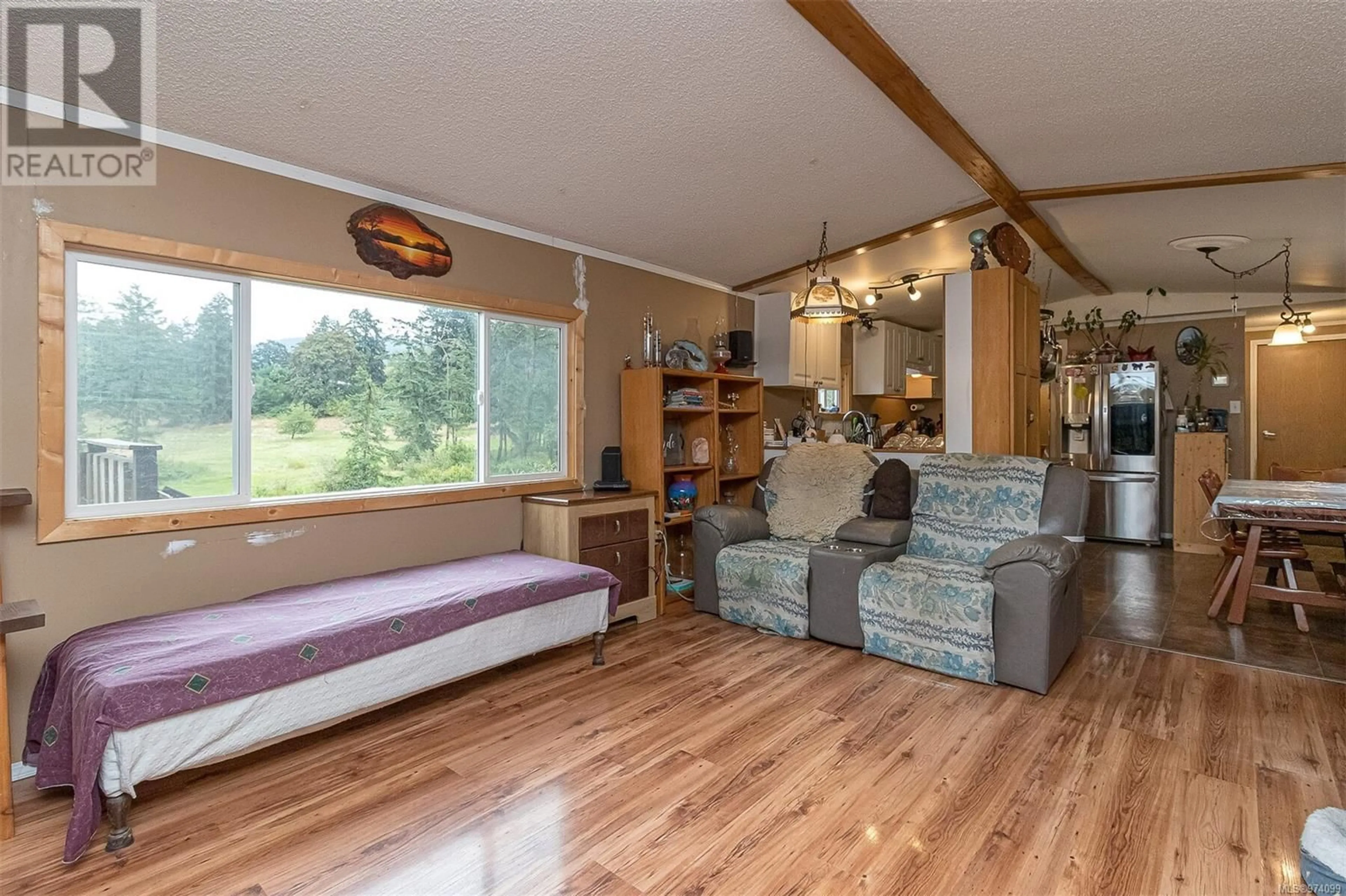 Living room with furniture, wood/laminate floor for 1781 Herd Rd, Duncan British Columbia V9L5W5