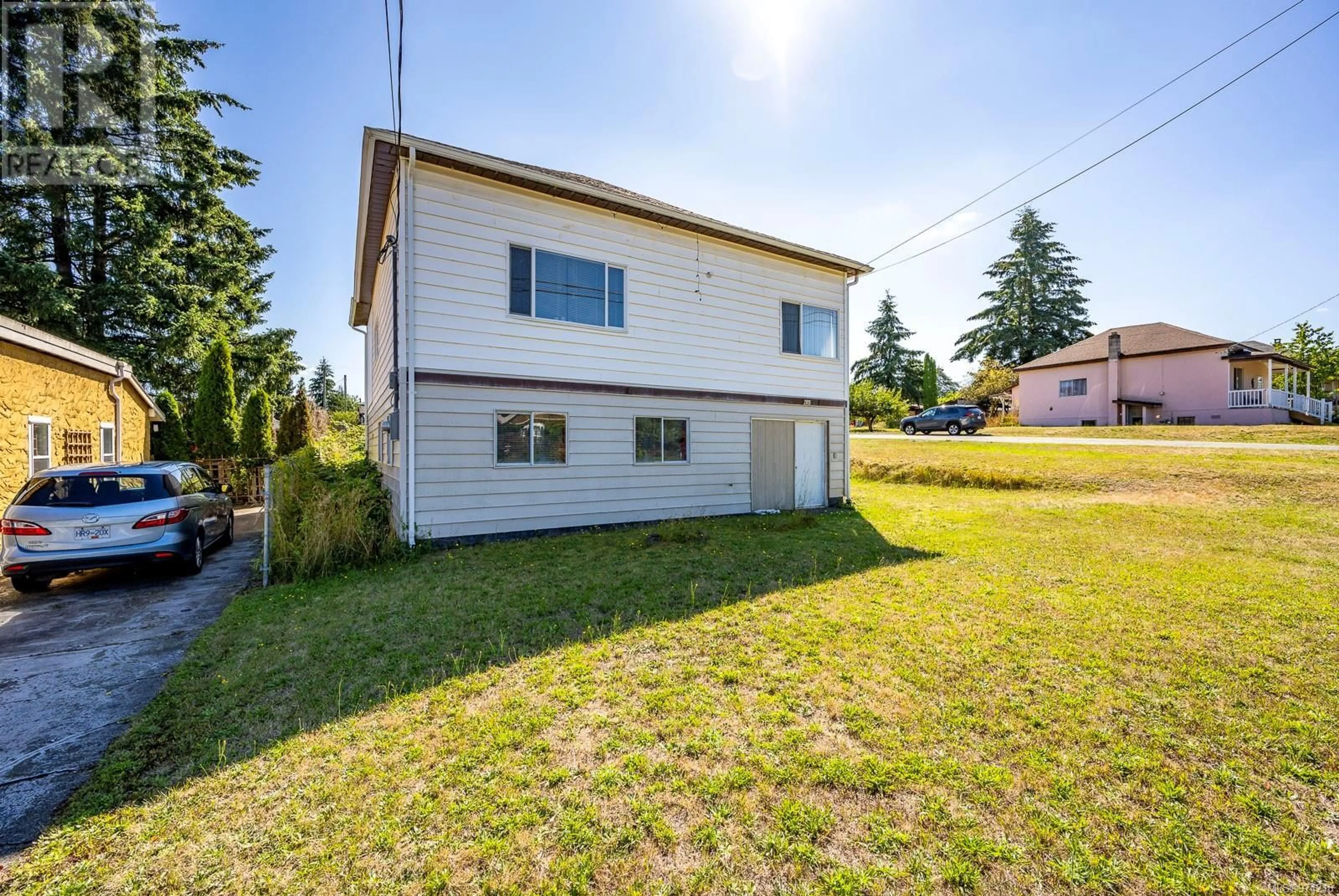 Frontside or backside of a home, the fenced backyard for 2815 Windermere Ave, Cumberland British Columbia V0R1S0