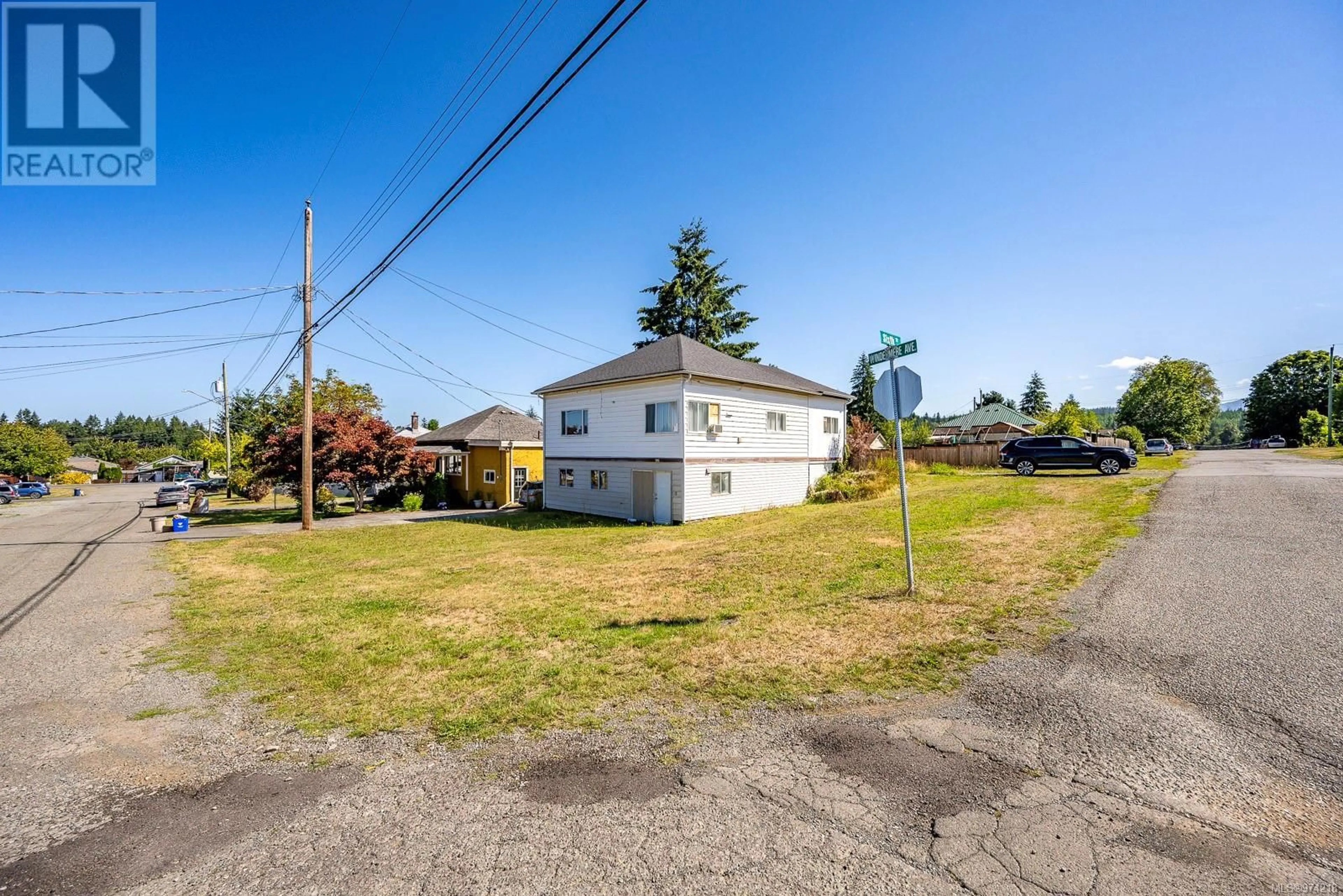 Frontside or backside of a home, the fenced backyard for 2815 Windermere Ave, Cumberland British Columbia V0R1S0