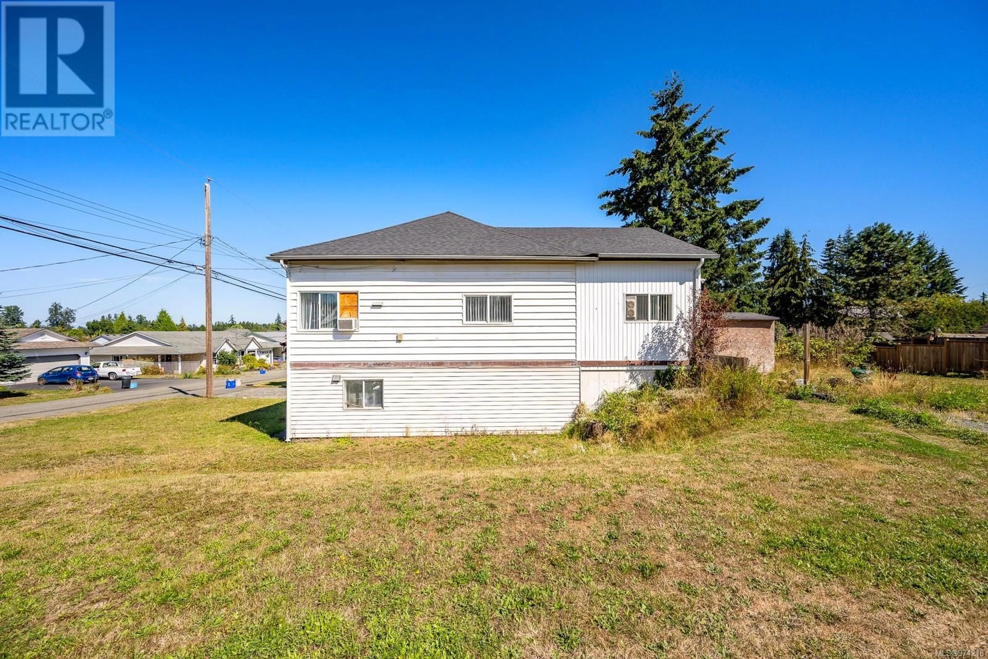 Frontside or backside of a home, the fenced backyard for 2815 Windermere Ave, Cumberland British Columbia V0R1S0