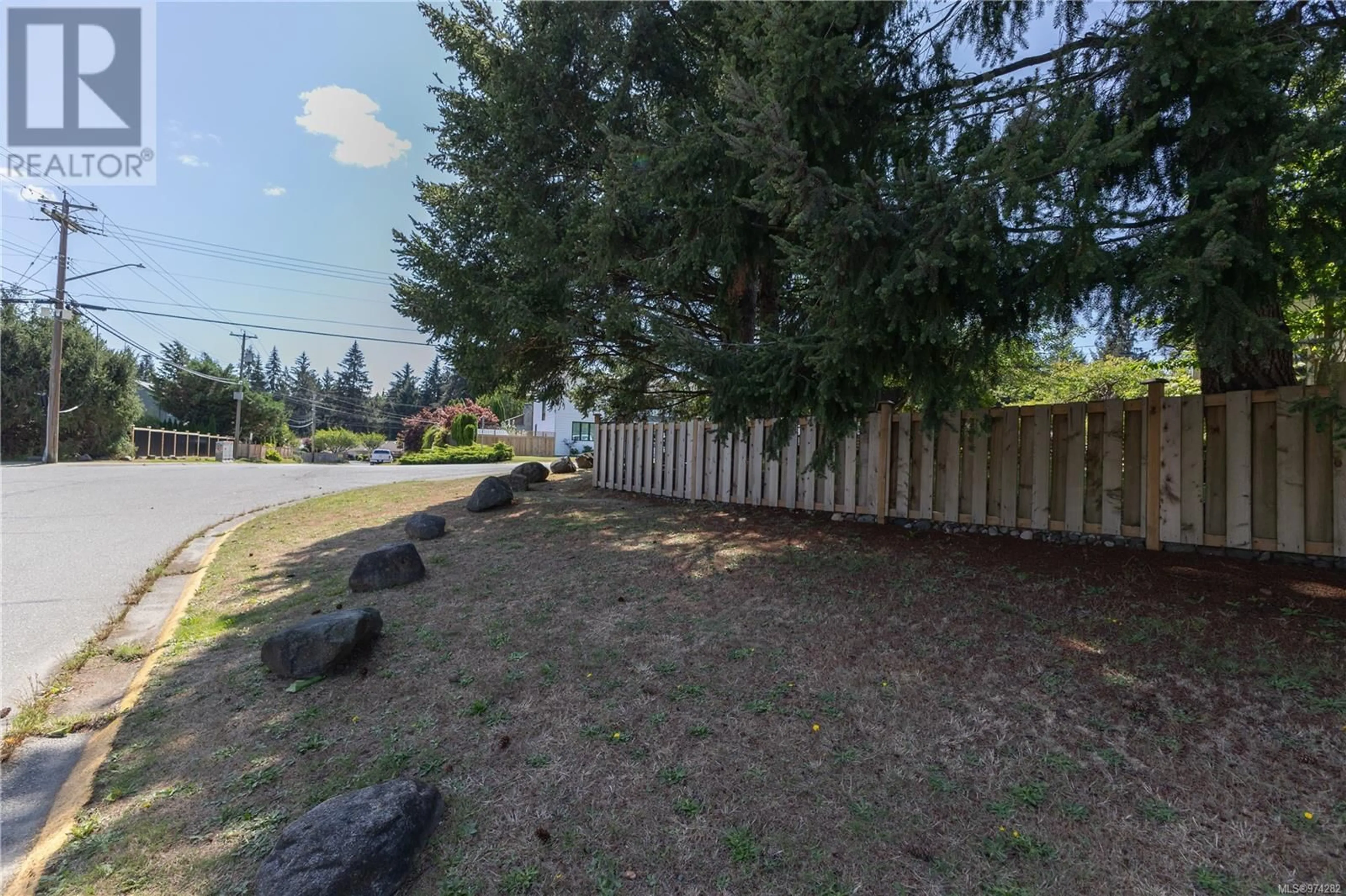 Frontside or backside of a home, the fenced backyard for 614 Springbok Rd, Campbell River British Columbia V9W7C2