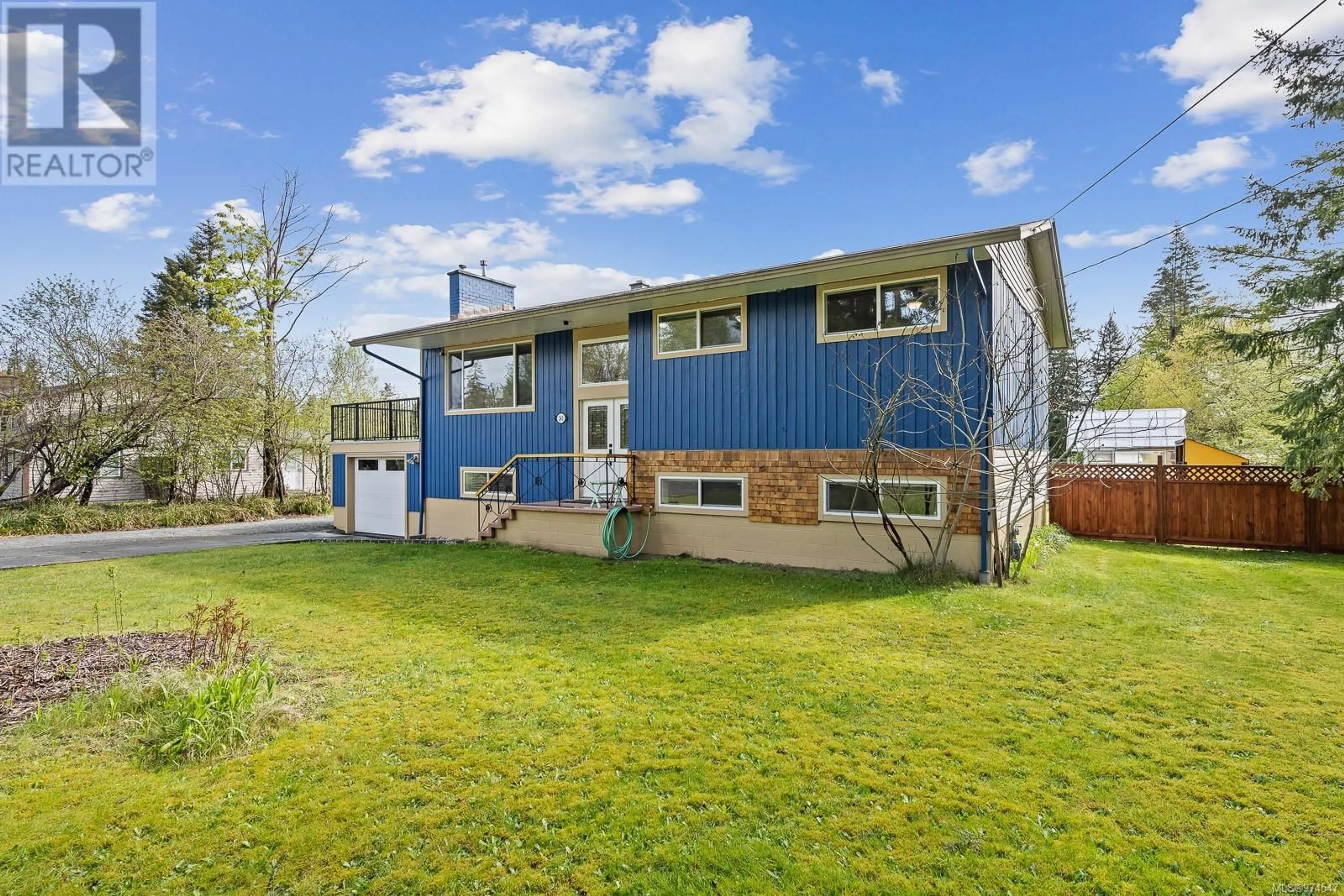 A pic from exterior of the house or condo, the fenced backyard for 241 Petersen Rd, Campbell River British Columbia V9W3H3