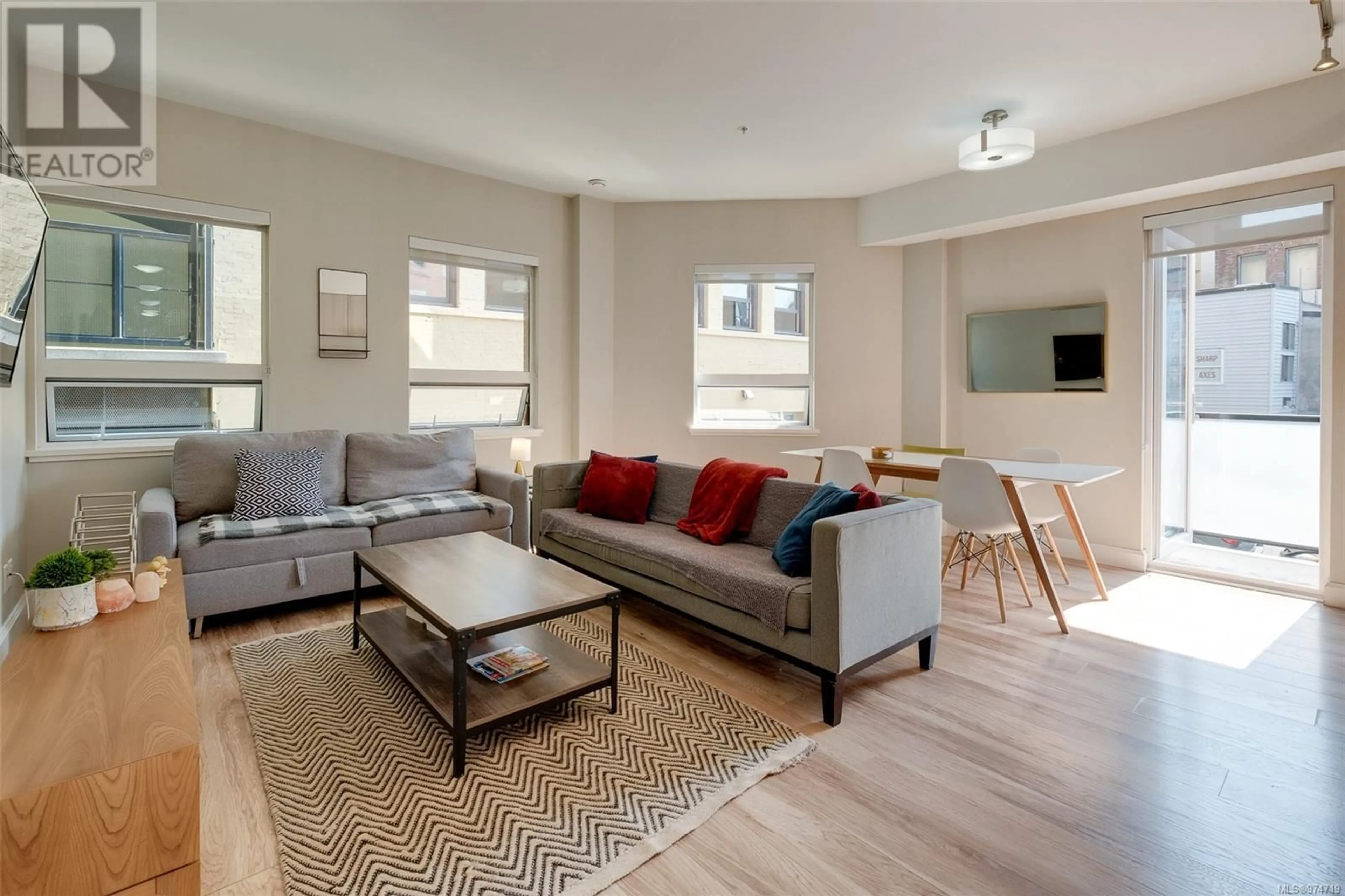Living room with furniture, wood/laminate floor for 101 - 595 PANDORA AVENUE, Victoria British Columbia V8W1N5