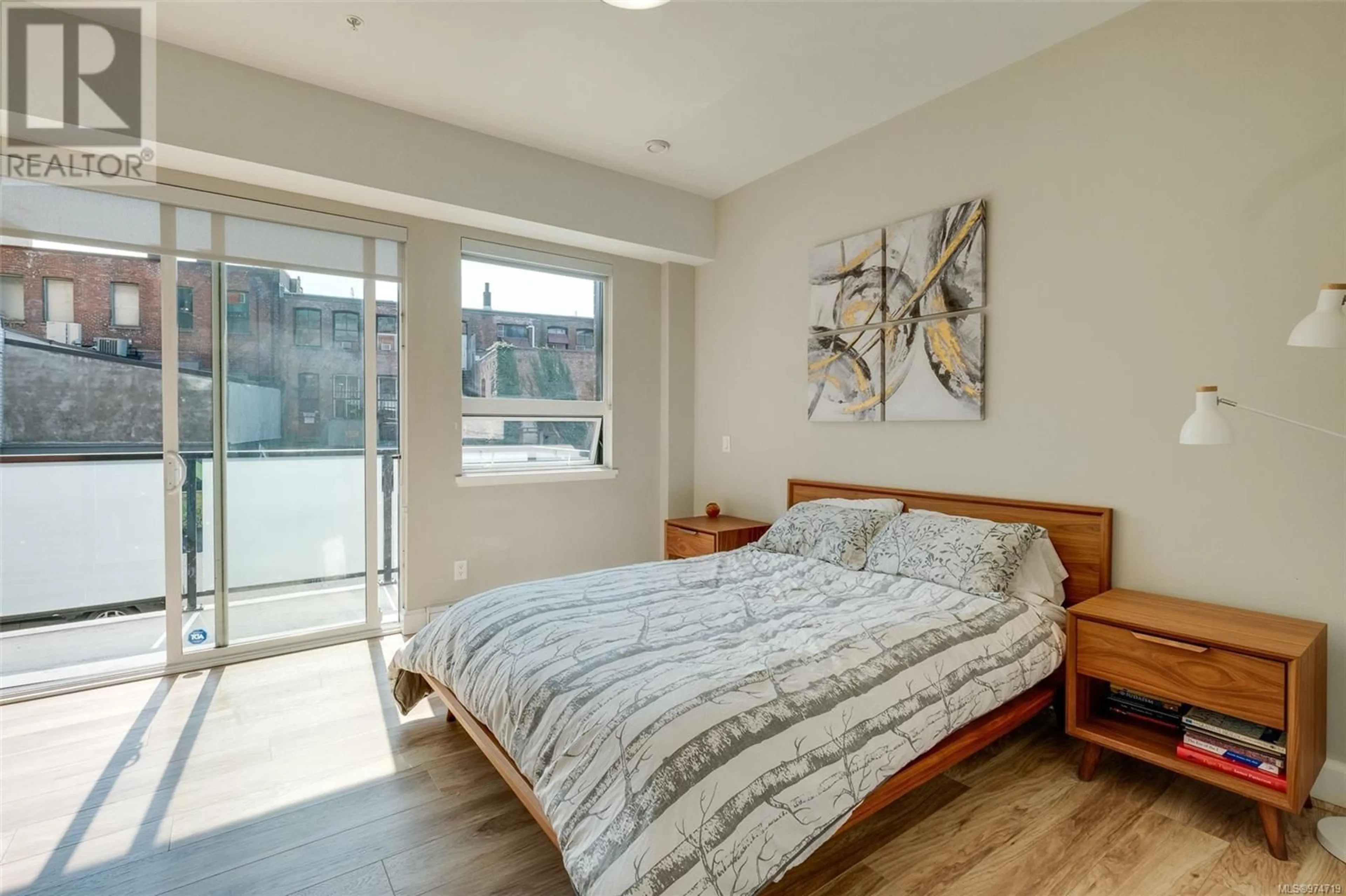 Bedroom with bed, wood/laminate floor for 101 - 595 PANDORA AVENUE, Victoria British Columbia V8W1N5
