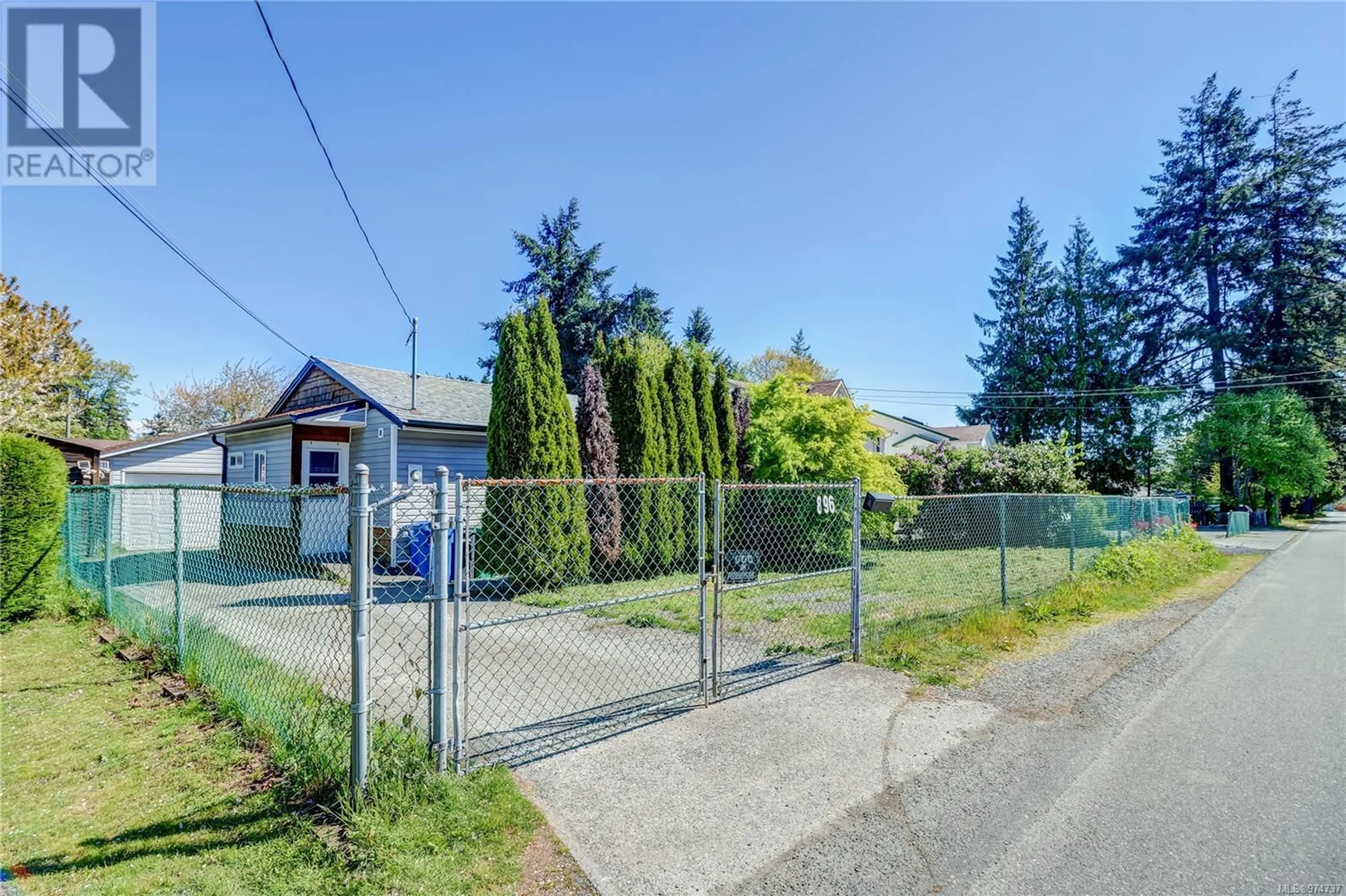 Frontside or backside of a home, the fenced backyard for 896 Townsite Rd, Nanaimo British Columbia V9S1L7