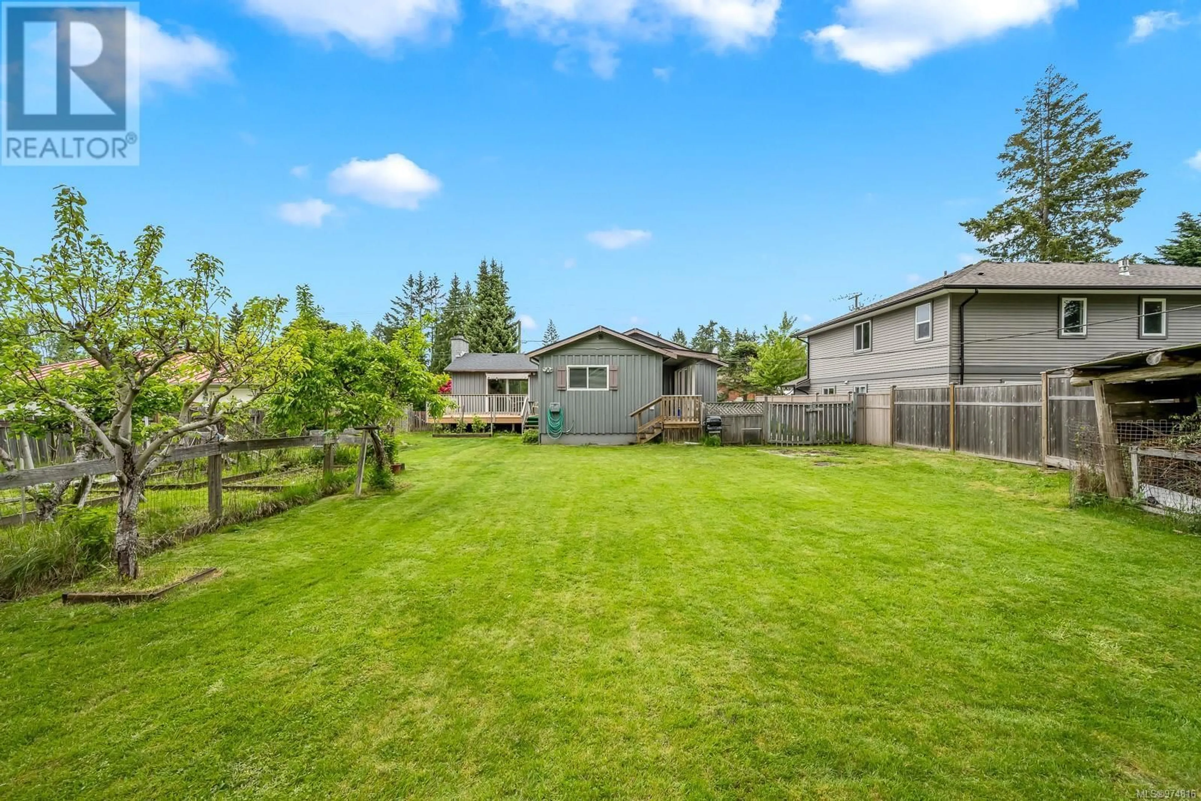 Frontside or backside of a home, the fenced backyard for 1535 Willemar Ave, Courtenay British Columbia V9N3M2