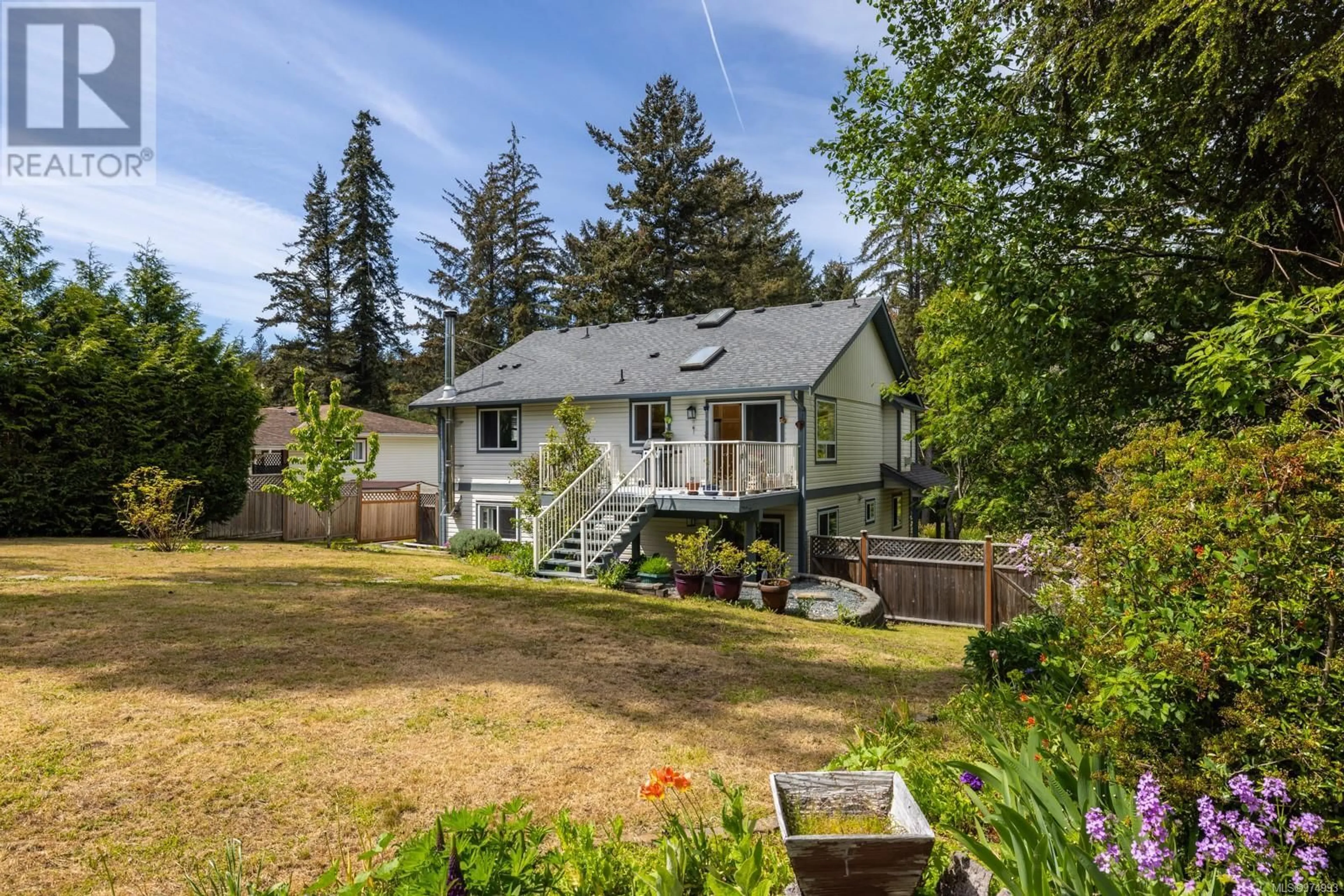 Frontside or backside of a home, the fenced backyard for 7141 Wright Rd, Sooke British Columbia V0S1N0