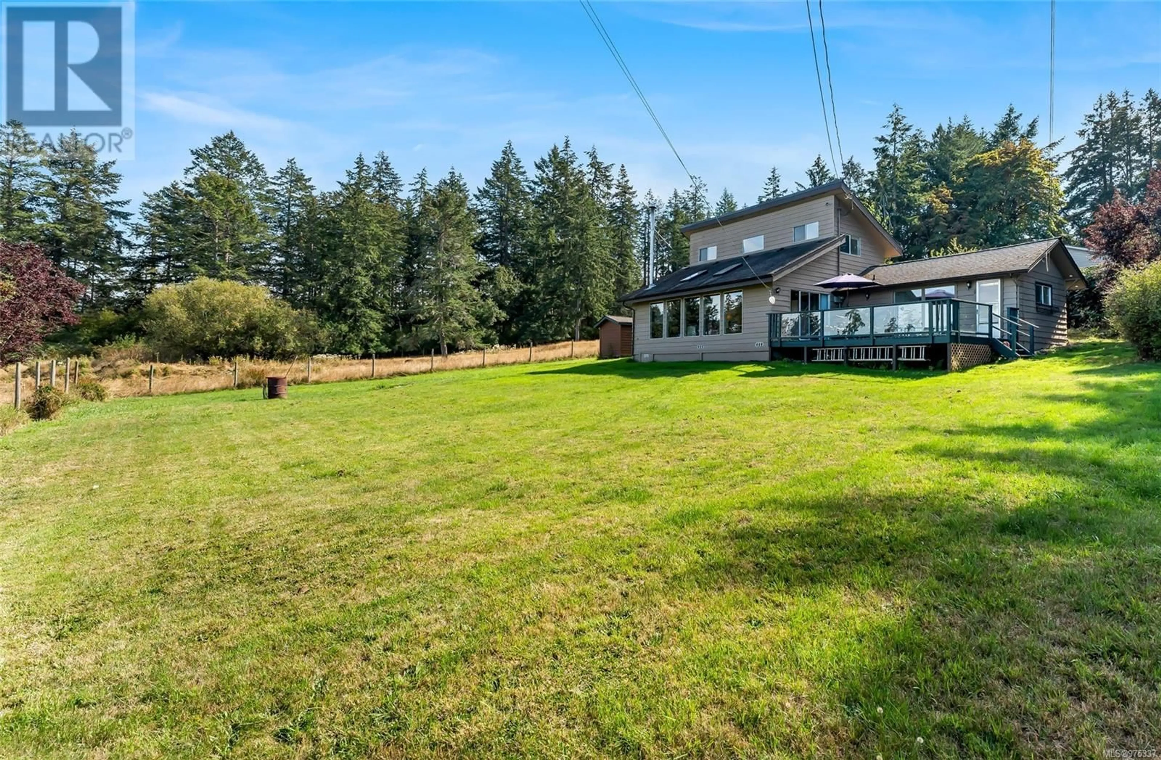 A pic from exterior of the house or condo, the fenced backyard for 301 Fernwood Rd, Salt Spring British Columbia V8K1C3