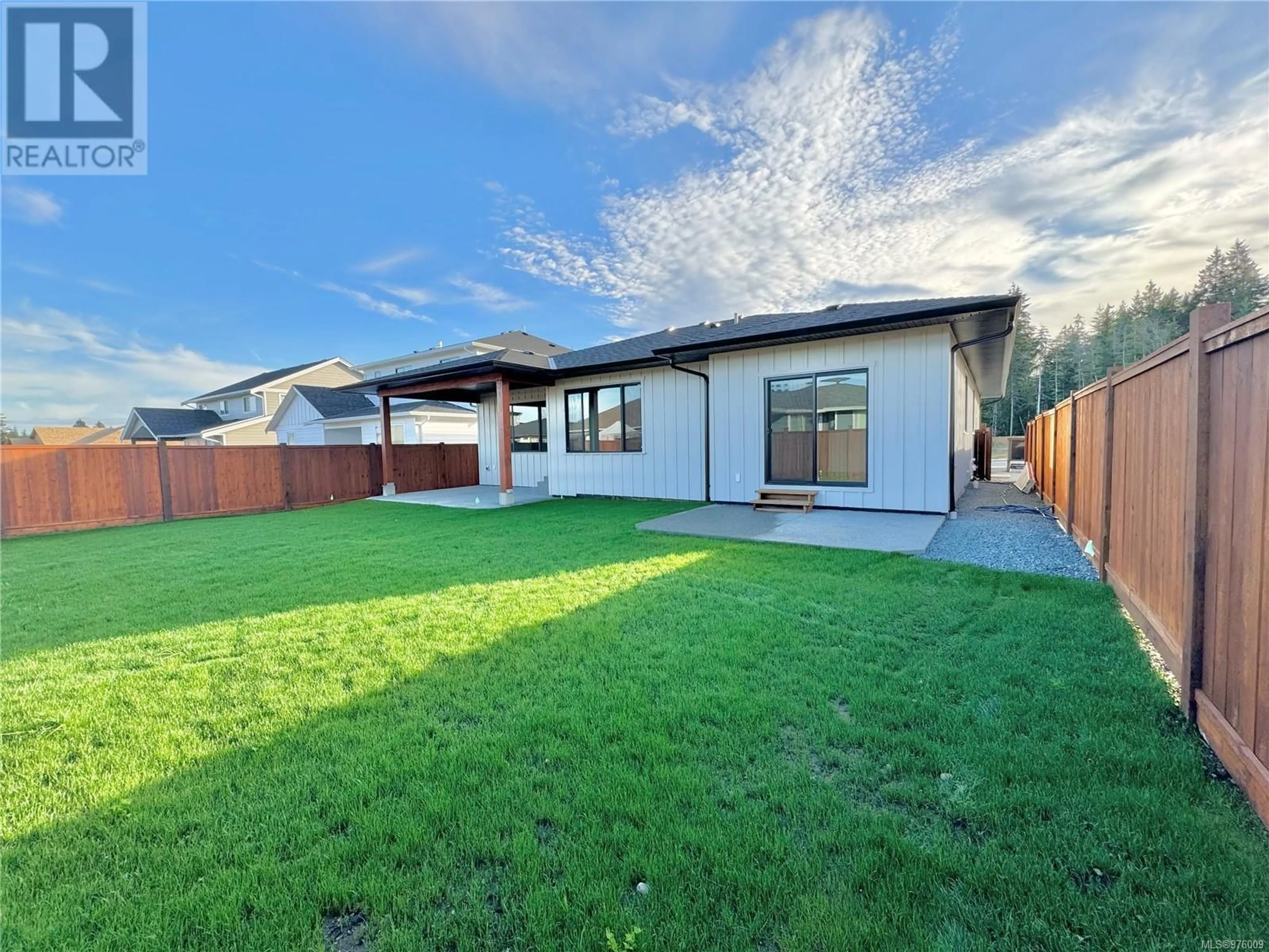 Frontside or backside of a home, the fenced backyard for 752 Beaver Creek Blvd, Campbell River British Columbia V9H0E9