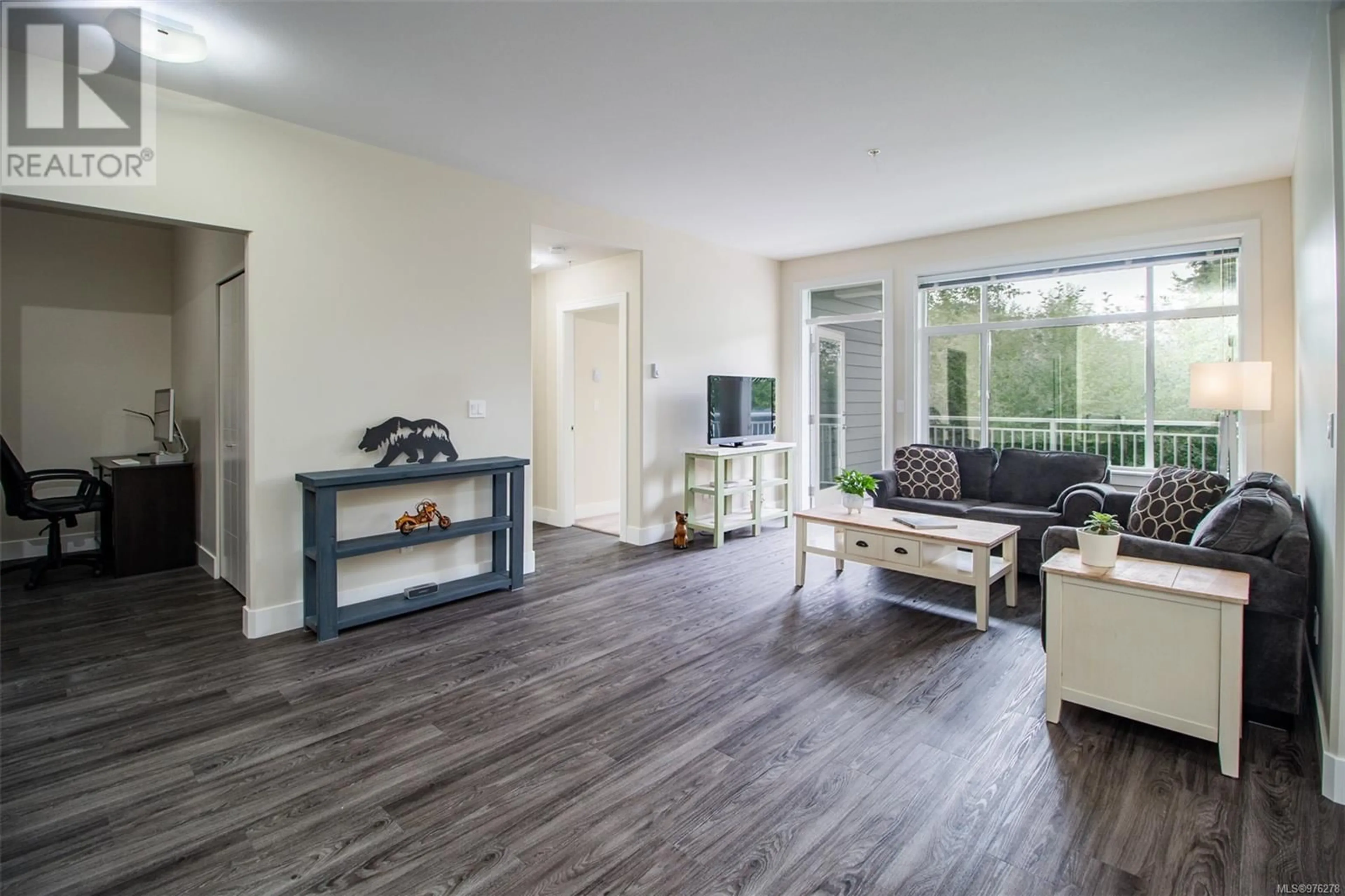 Living room with furniture, wood/laminate floor for 206 4960 Songbird Pl, Nanaimo British Columbia V9T6L1