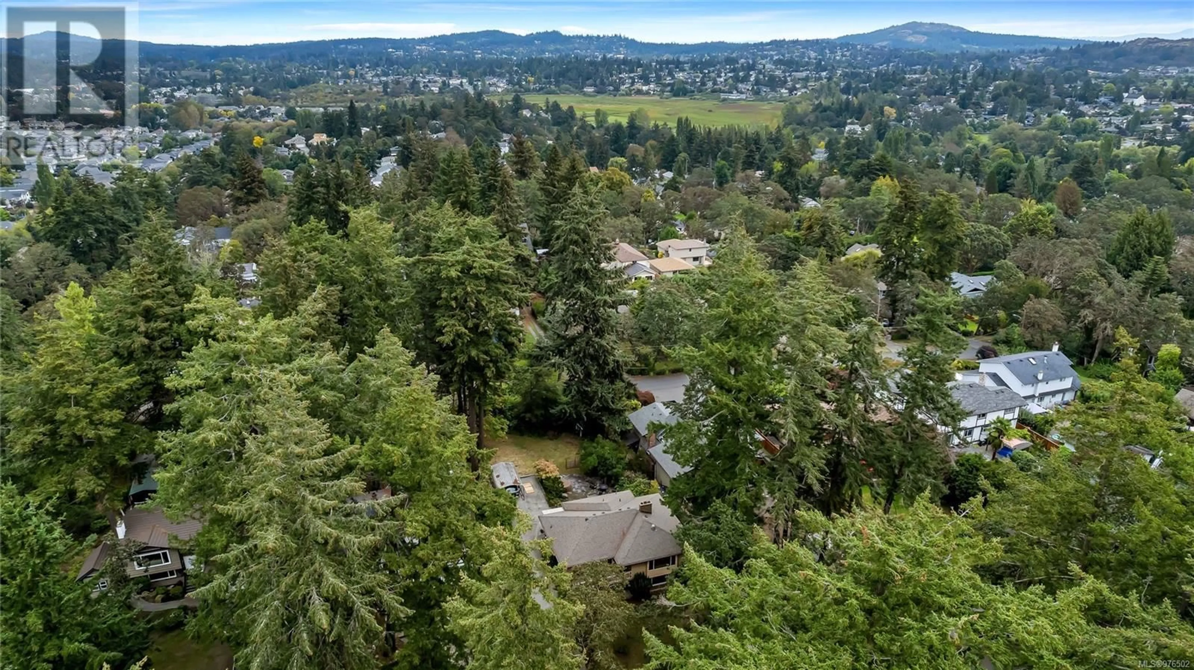 A pic from exterior of the house or condo, the fenced backyard for 1070 Iris Ave, Saanich British Columbia V8Z2N7