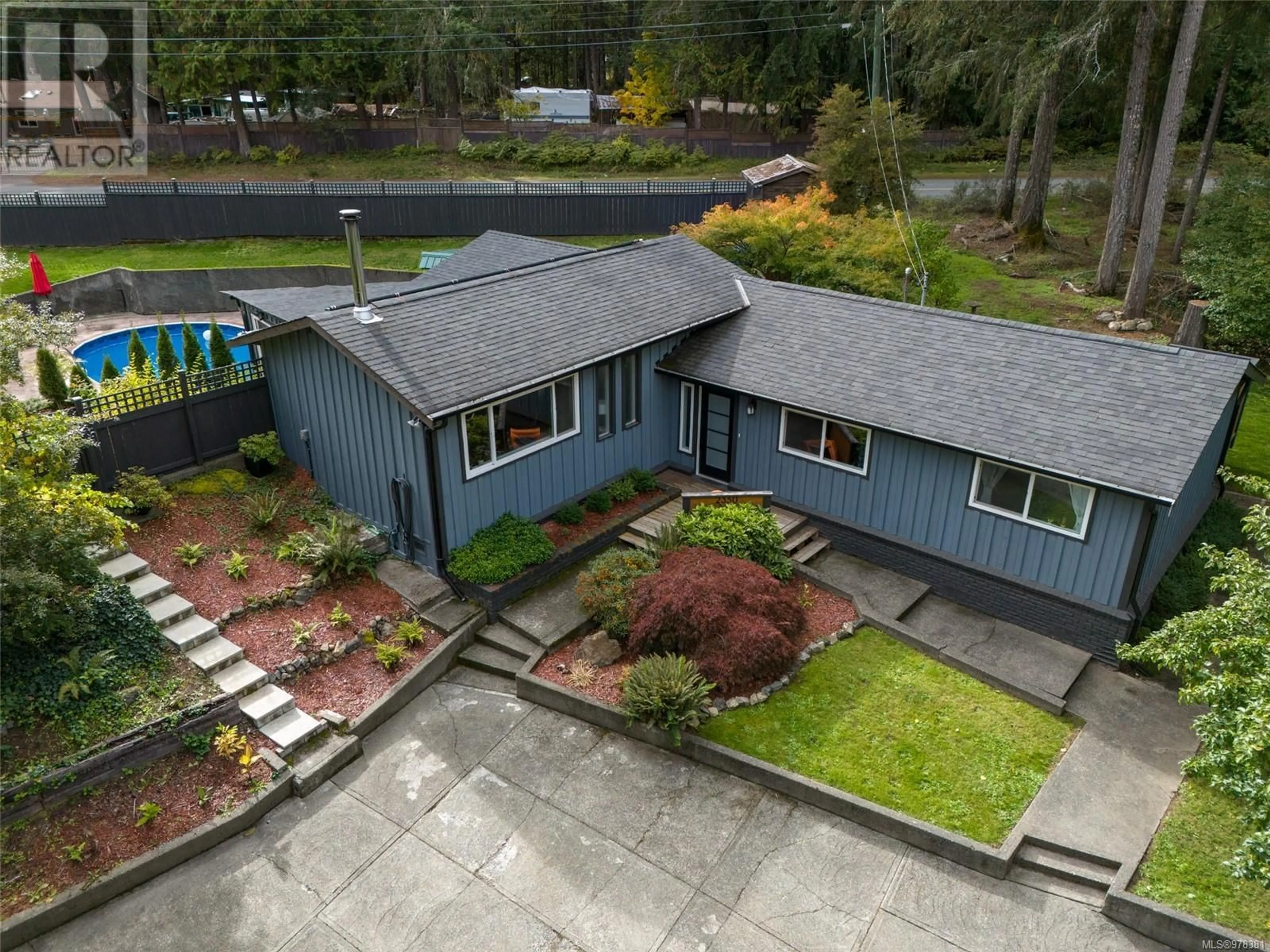 Frontside or backside of a home, the fenced backyard for 2350 Kews Rd, Shawnigan Lake British Columbia V0R2W3