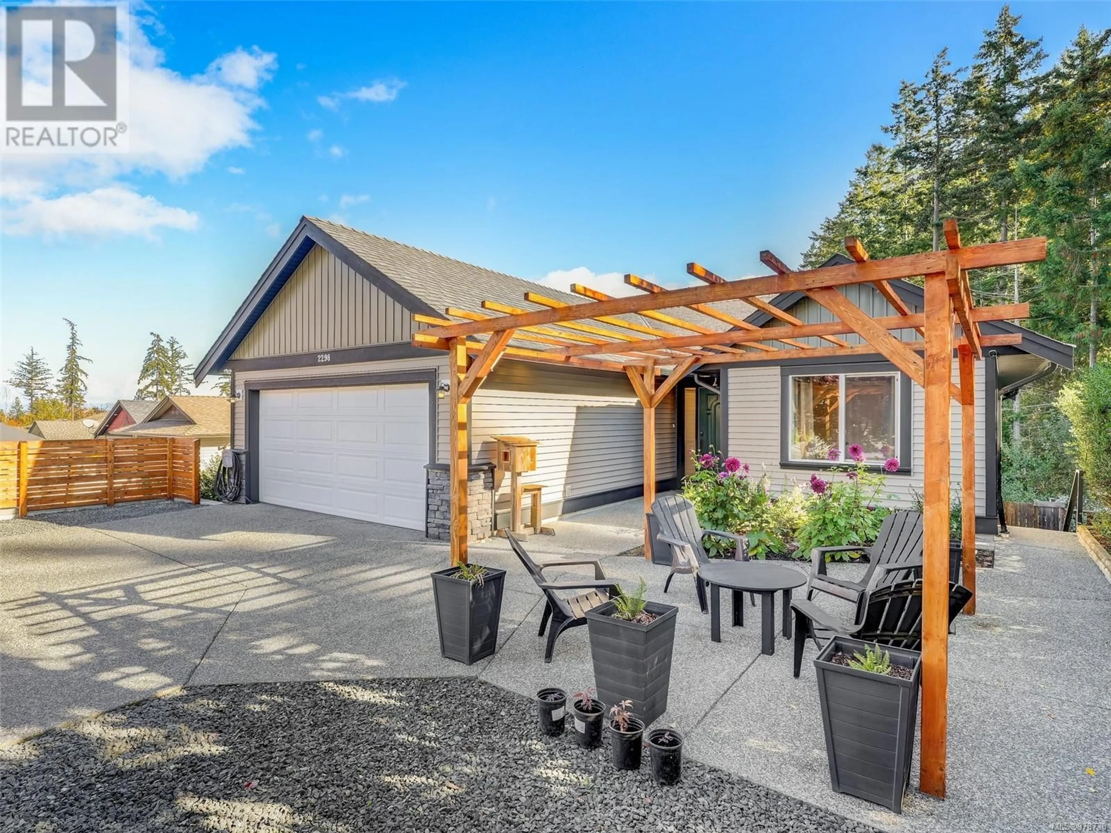 Frontside or backside of a home, the fenced backyard for 2298 Kingsford Pl, Nanaimo British Columbia V9X1Y3