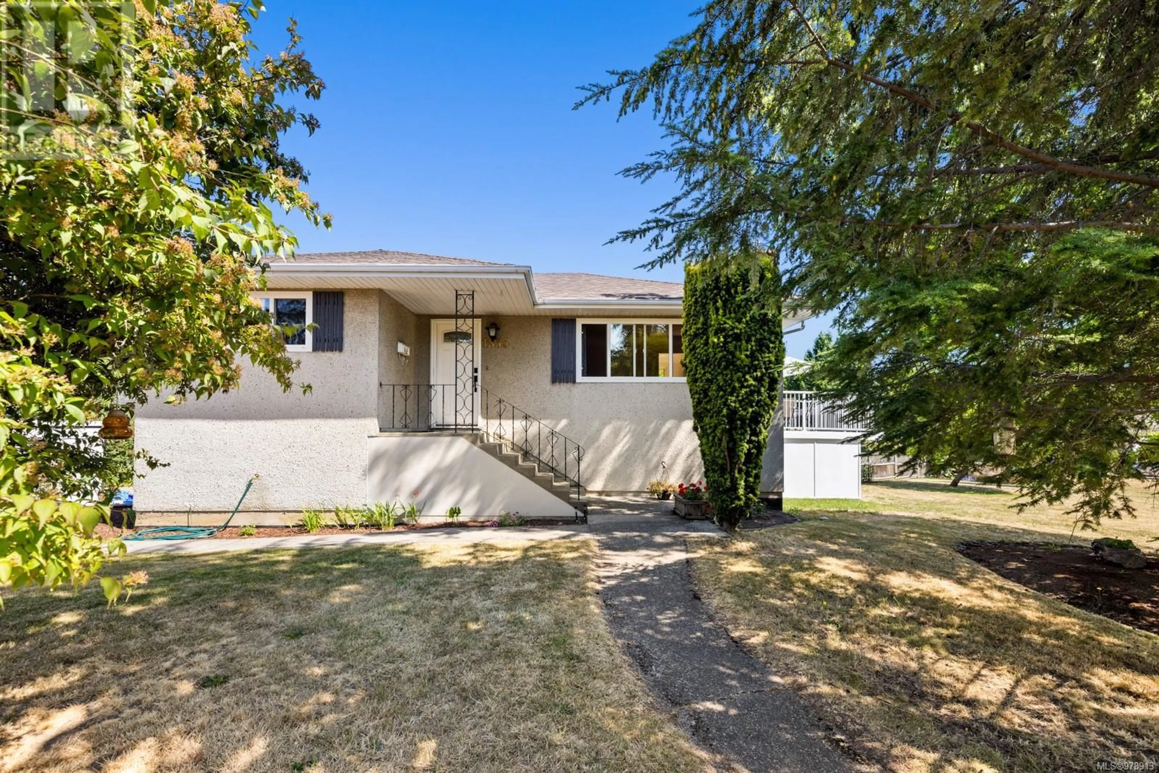 Frontside or backside of a home, the fenced backyard for 1535 Stockton Cres, Saanich British Columbia V8P3B9