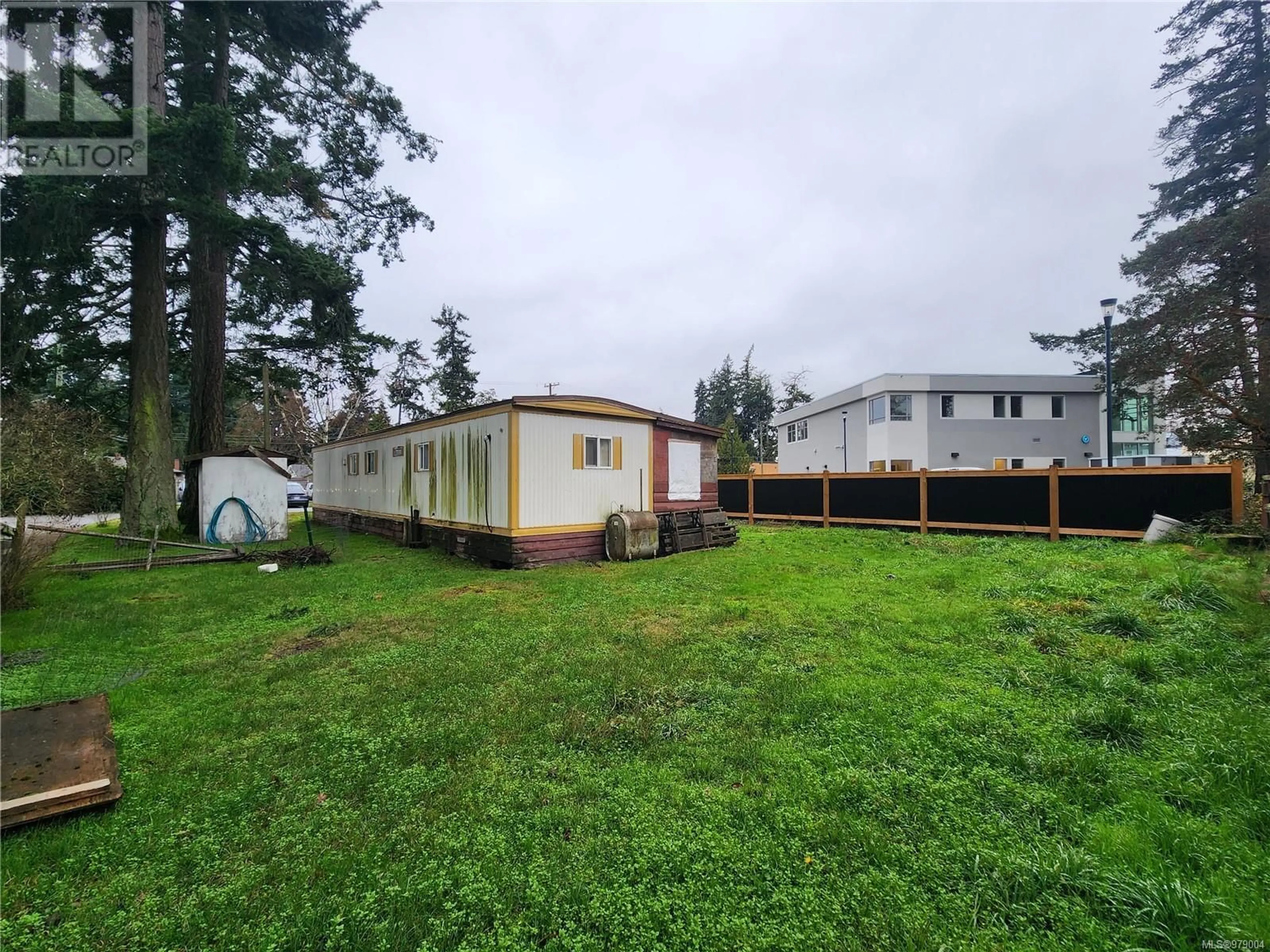 Frontside or backside of a home, the fenced backyard for 592 Heatherly Rd, Colwood British Columbia V9C1K1