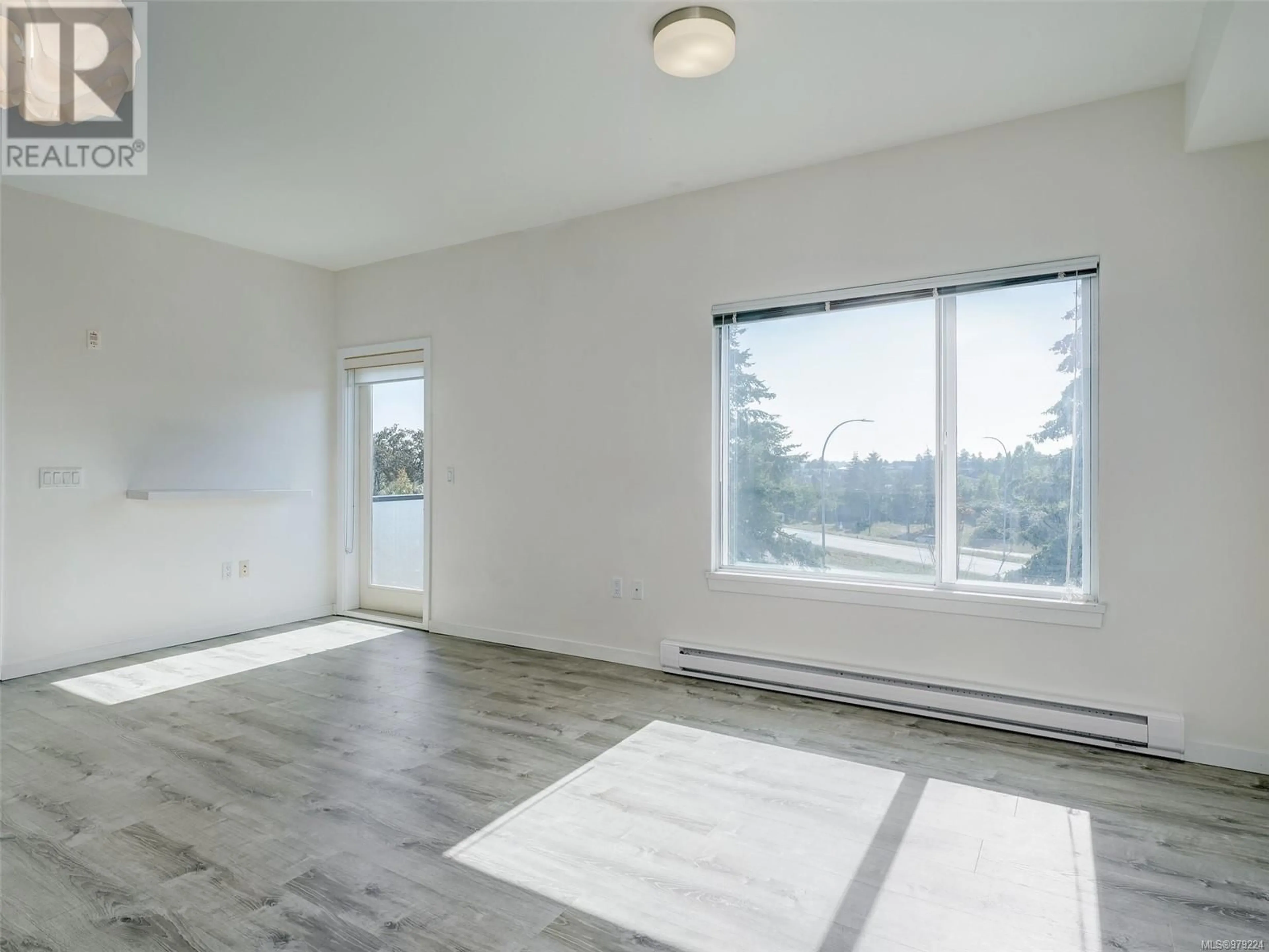 A pic of a room, wood floors for 303 4052 Douglas St, Saanich British Columbia V8X0A5