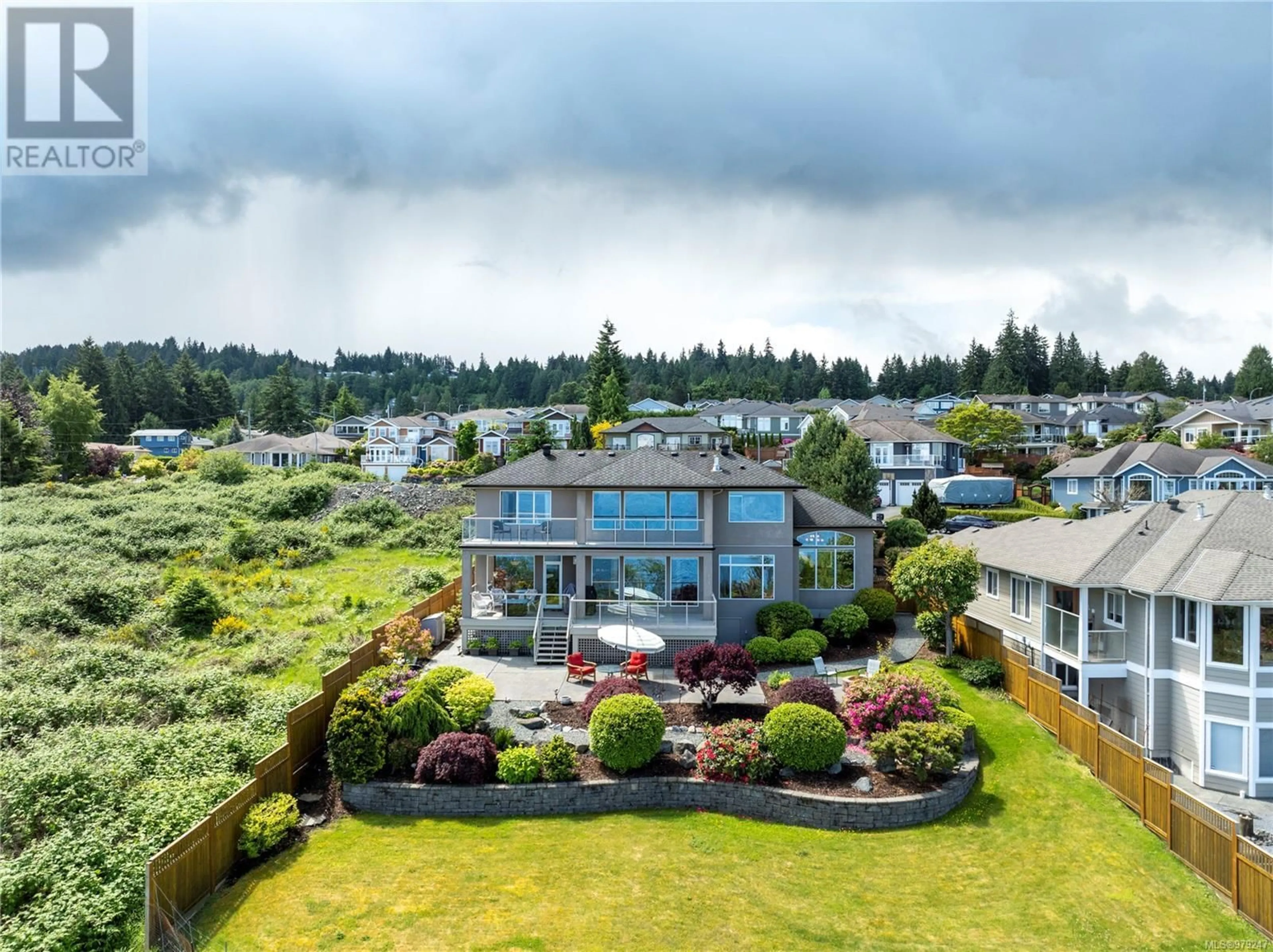 A pic from exterior of the house or condo, the fenced backyard for 6063 Breonna Dr, Nanaimo British Columbia V9V1G1